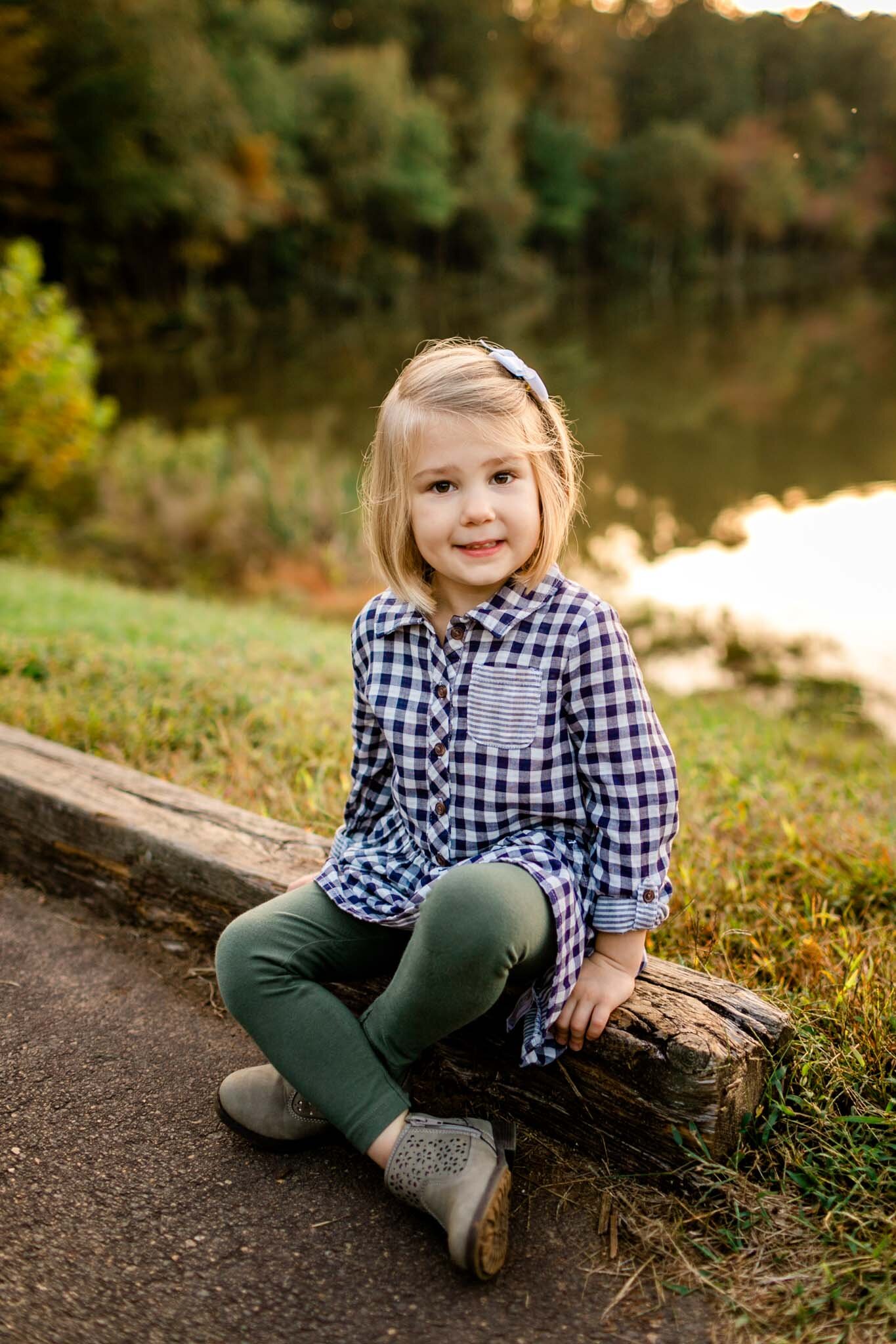 Raleigh Family Photographer | Umstead Park | By G. Lin Photography | Young girl sitting on log
