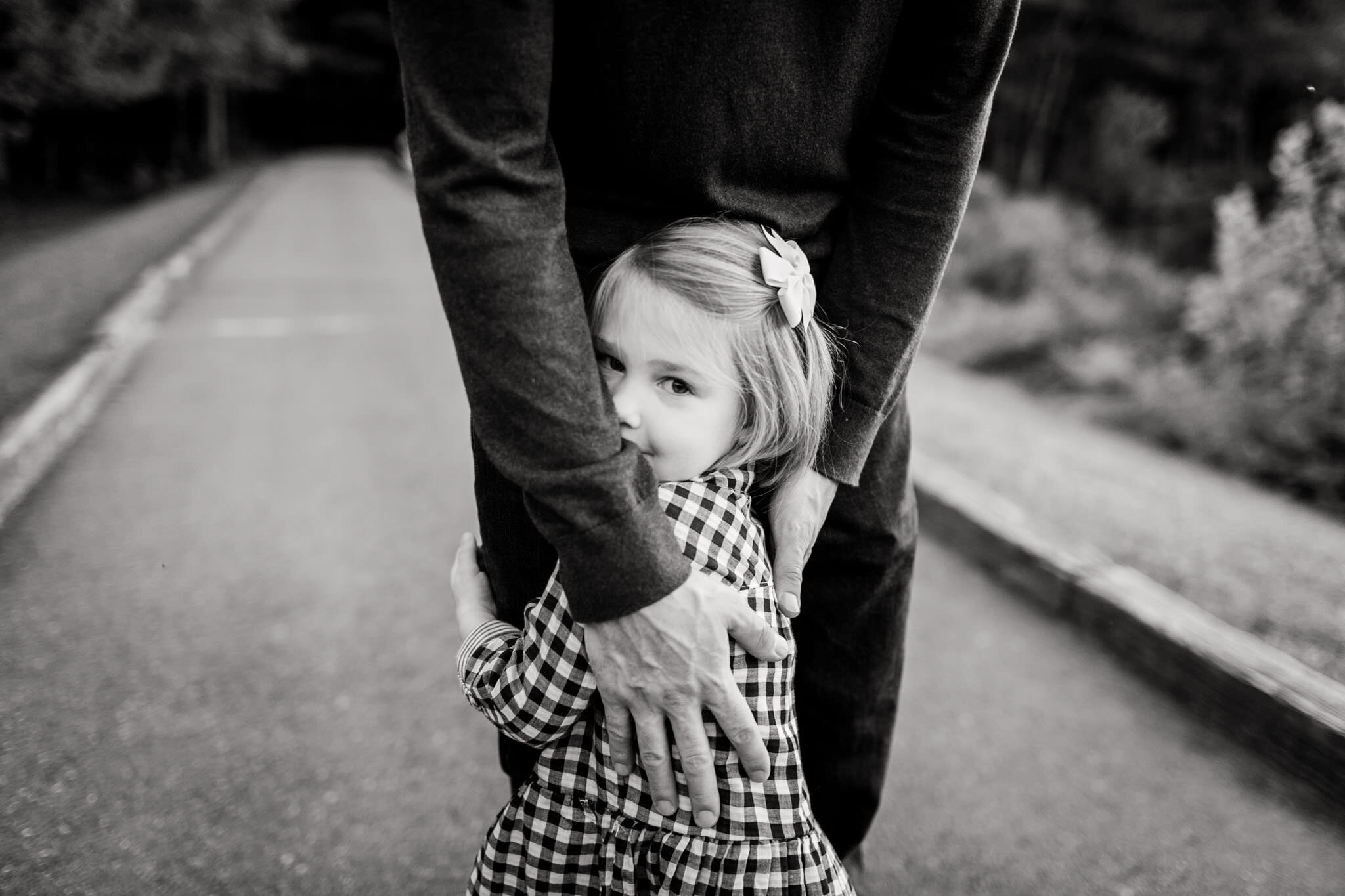 Raleigh Family Photographer | Umstead Park | By G. Lin Photography | Black and white portrait of young girl hugging dad