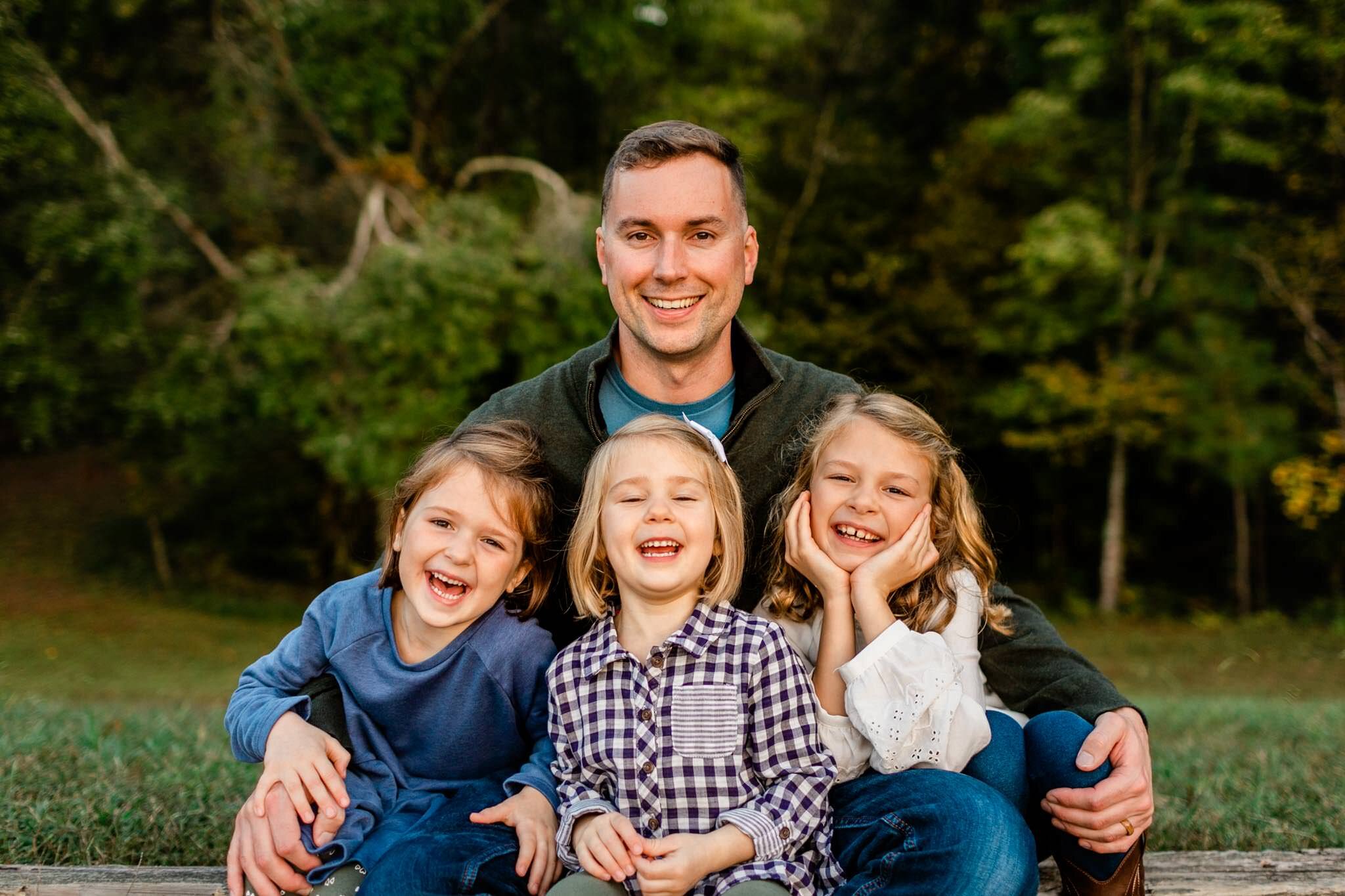 Raleigh Family Photographer | Umstead Park | By G. Lin Photography | Dad hugging daughters