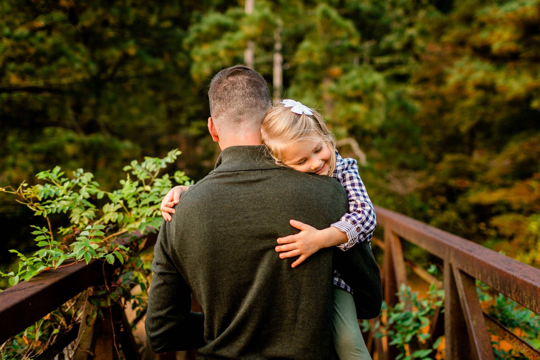 Raleigh Family Photographer | Umstead Park | By G. Lin Photography | Young girl hugging dad while being carried