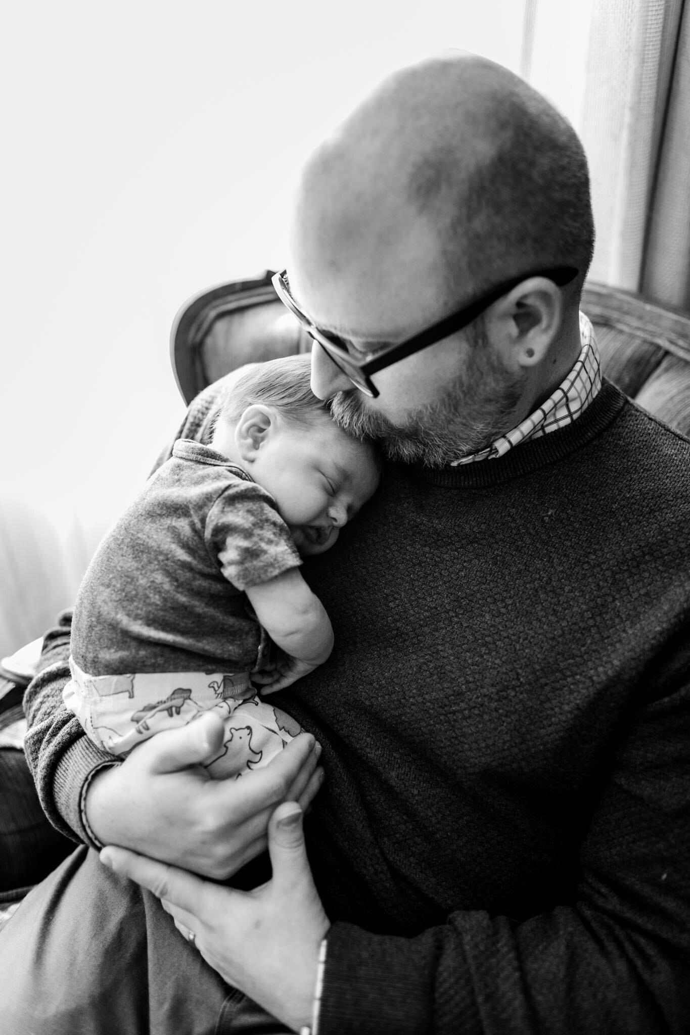 Raleigh Newborn Photographer | By G. Lin Photography | Black and white photo of dad holding baby boy