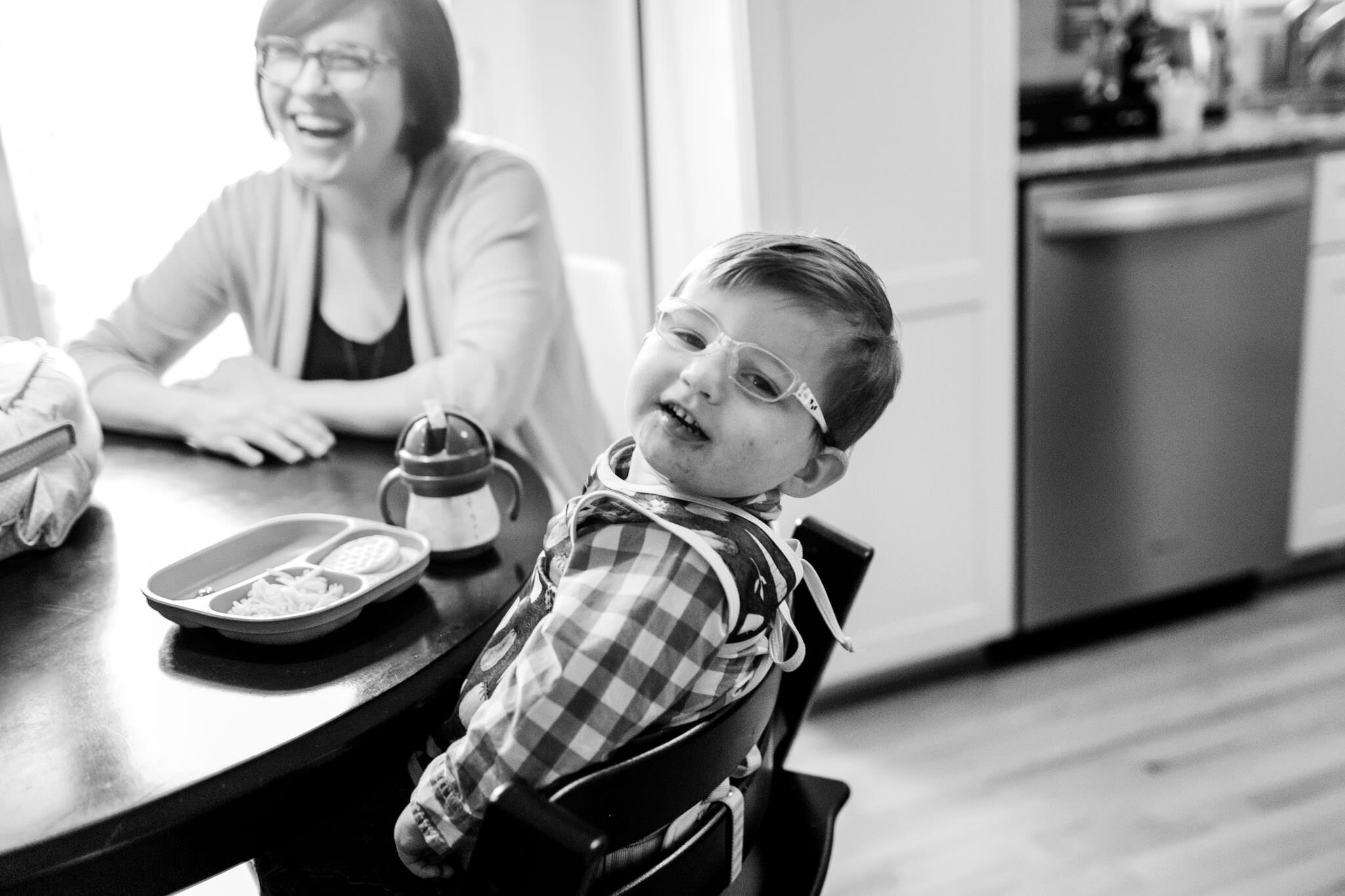 Raleigh Lifestyle Family Photographer | By G. Lin Photography | Young boy smiling at dining table