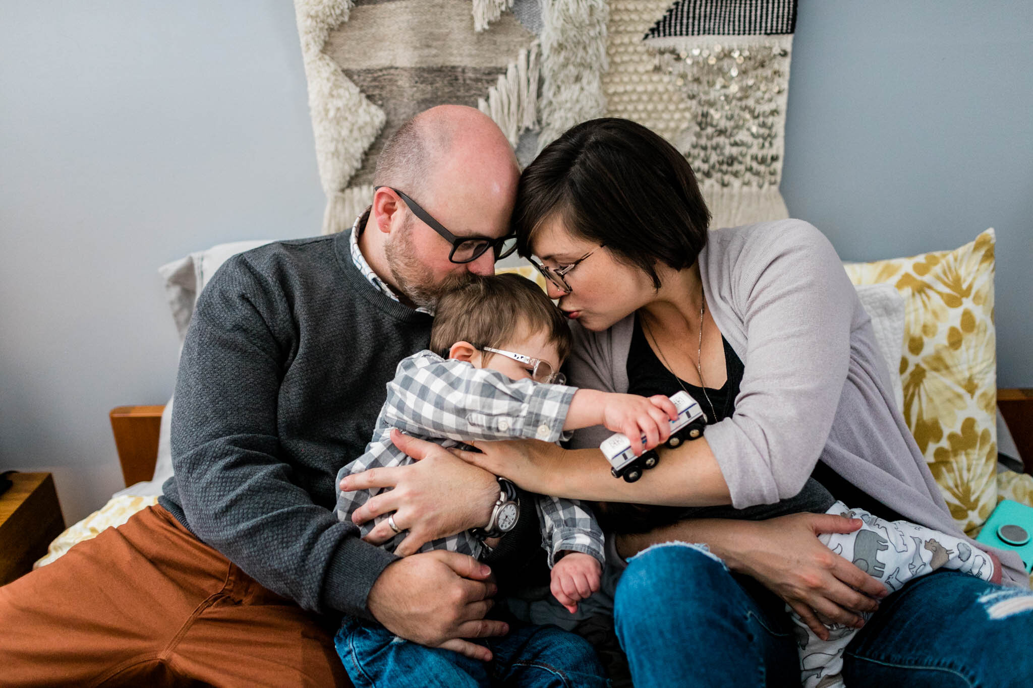 Raleigh Lifestyle Family Photographer | By G. Lin Photography | Parents kissing son on head