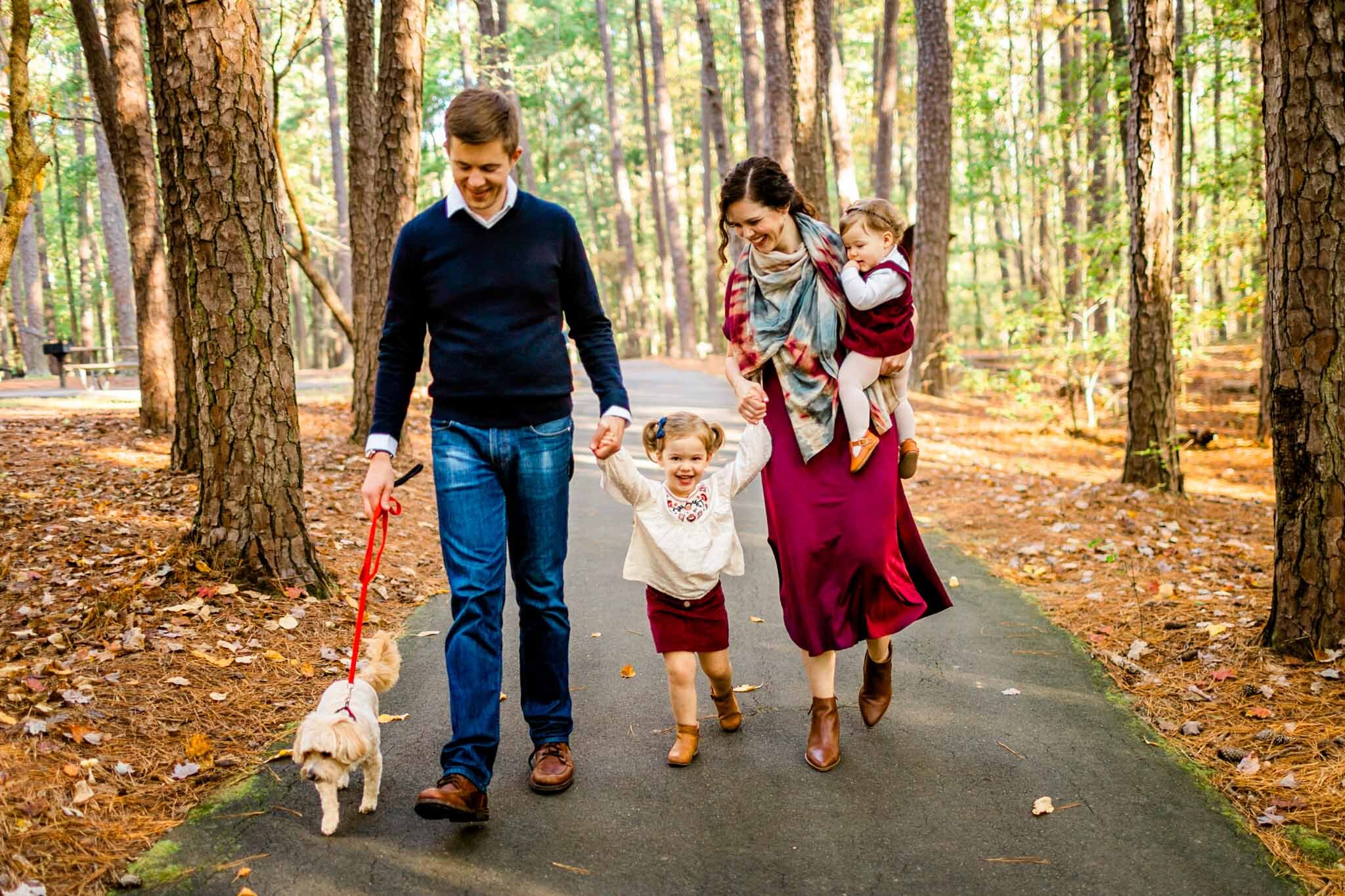 Raleigh Family Photographer | By G. Lin Photography | Umstead Park | Family walking together and laughing and smiling
