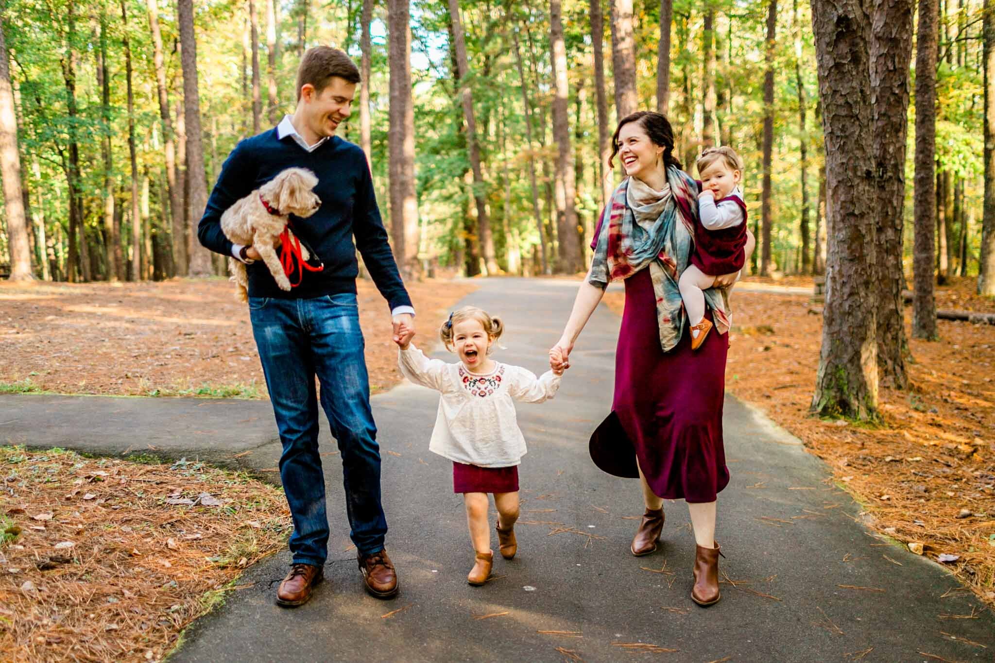 Raleigh Family Photographer | By G. Lin Photography | Umstead Park | Family walking on paved path in forest