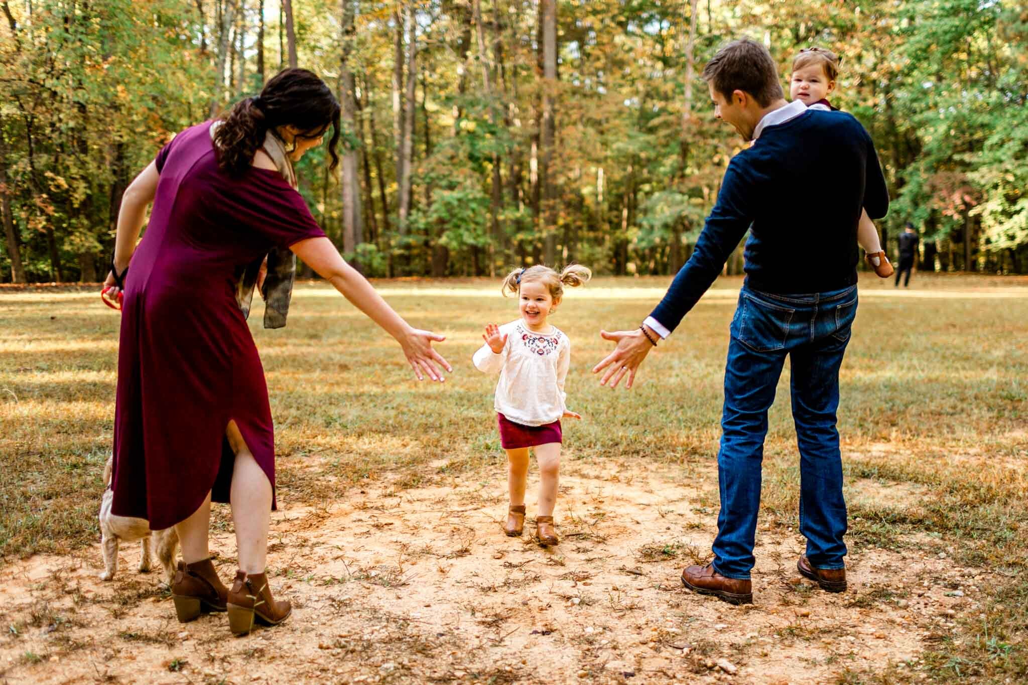 Raleigh Family Photographer | By G. Lin Photography | Umstead Park | Young girl giving high fives to parents