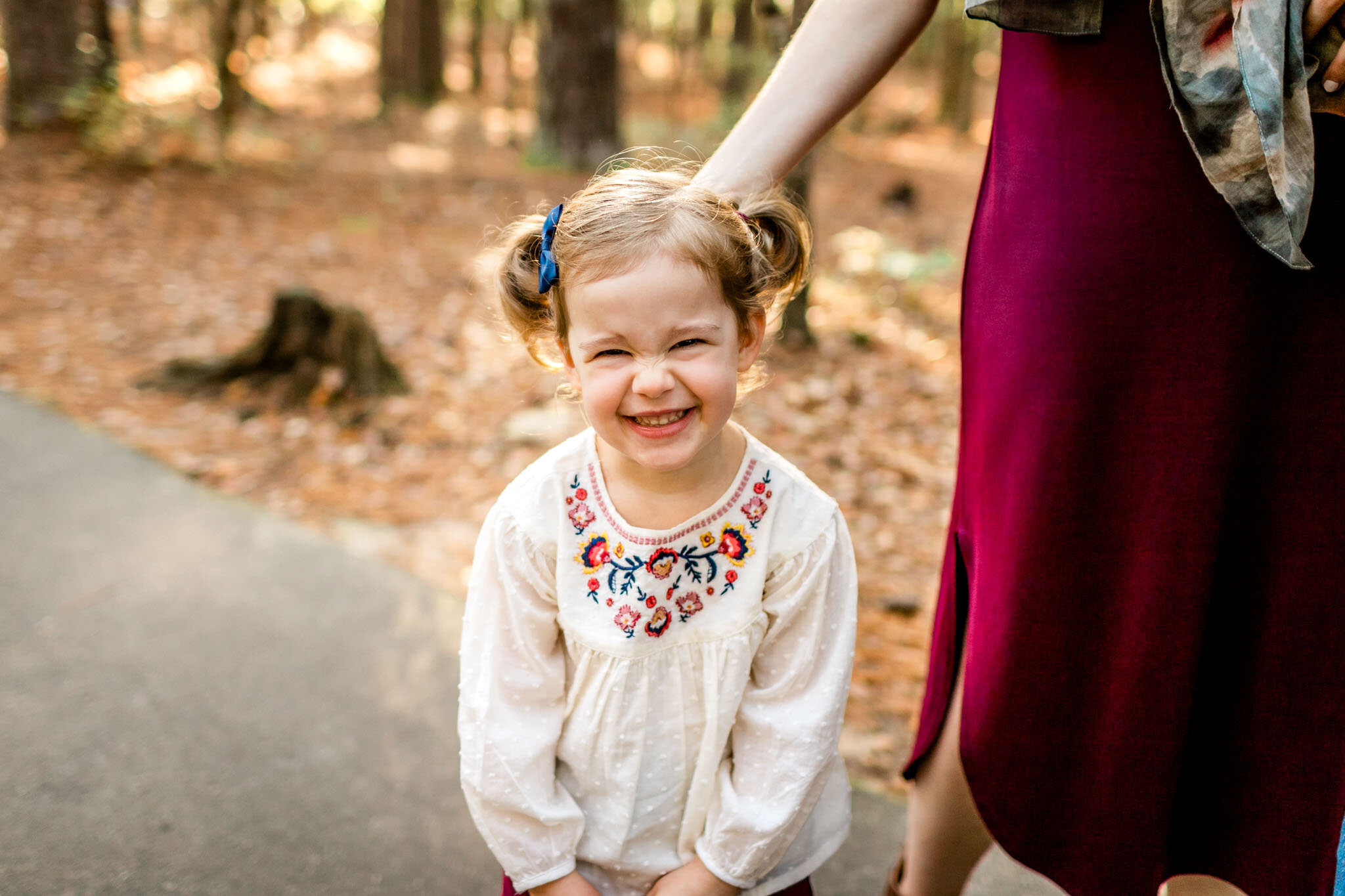 Raleigh Family Photographer | By G. Lin Photography | Umstead Park Fall Photos | Toddler girl smiling