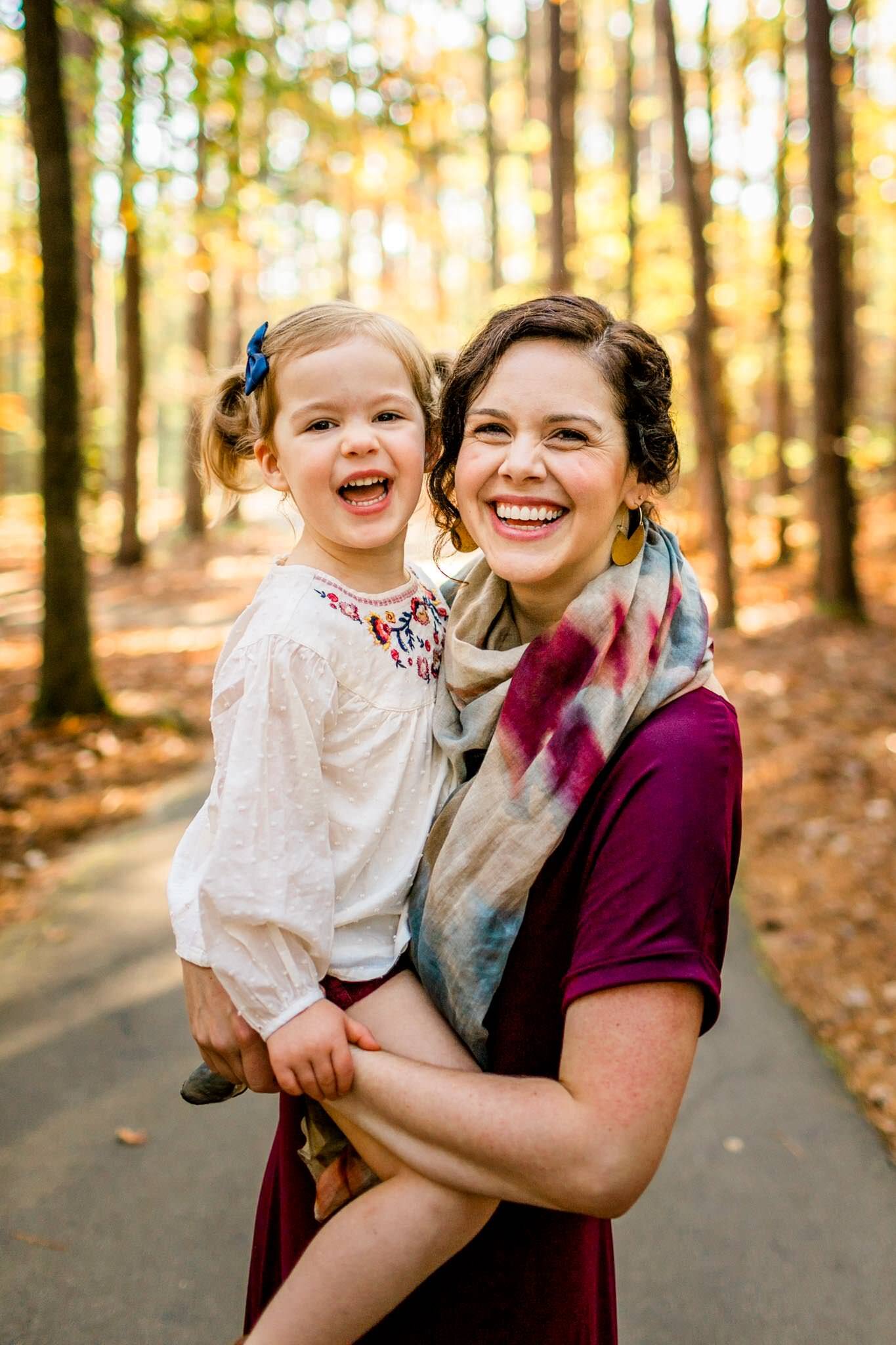 Raleigh Family Photographer | By G. Lin Photography | Umstead Park | Mother holding toddler girl and smiling at camera