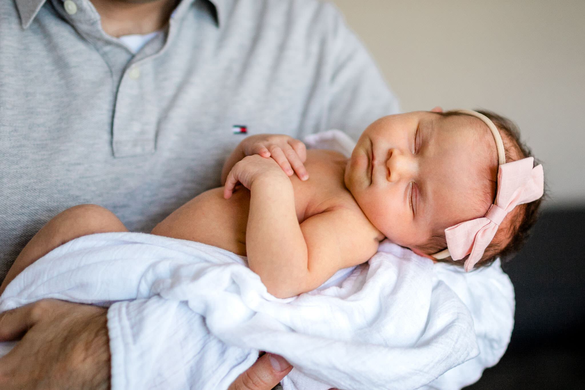 Raleigh Newborn Photographer | By G. Lin Photography | Close up image of baby girl sleeping in father's arms