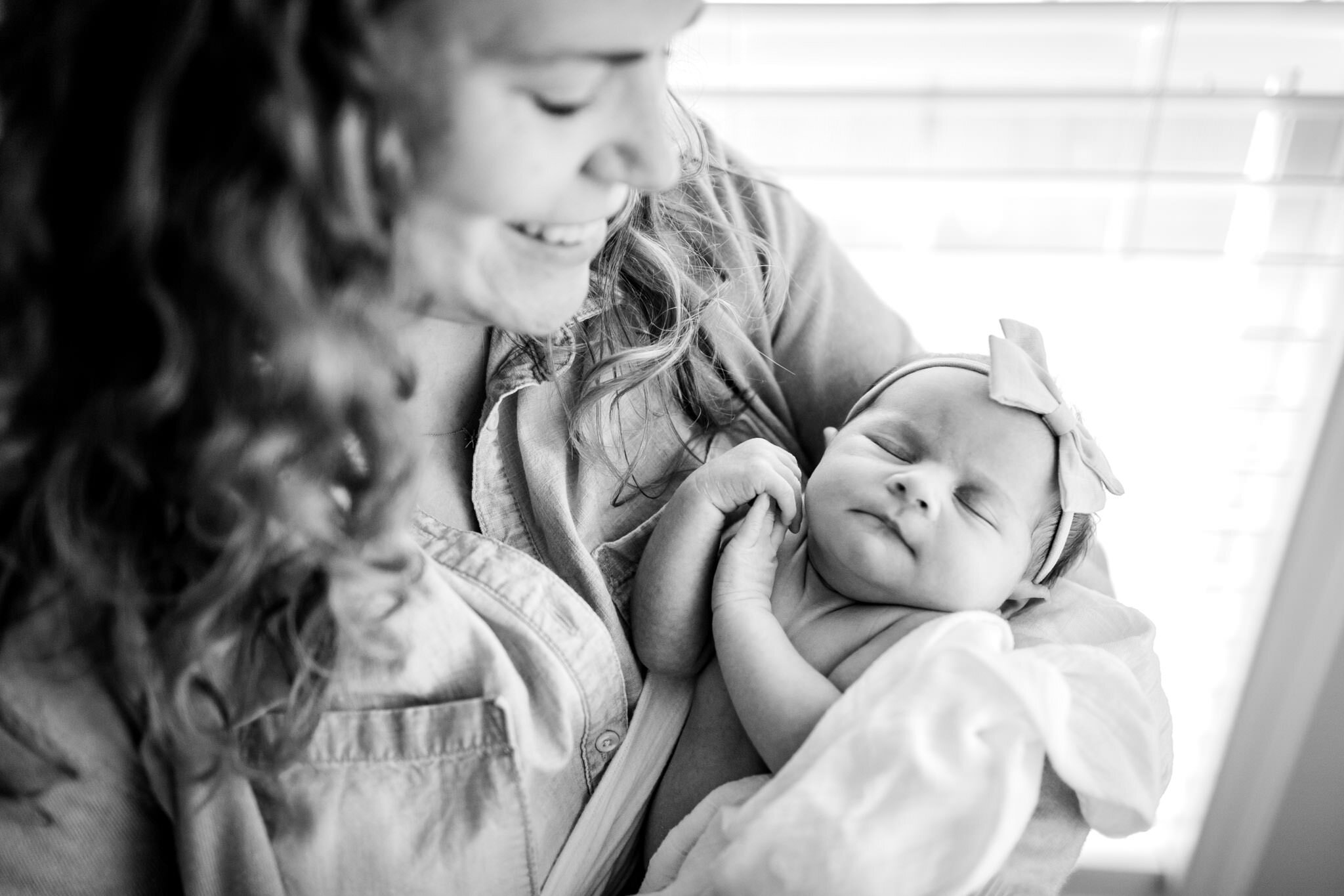 Raleigh Newborn Photographer | By G. Lin Photography | Black and white image of mother holding baby