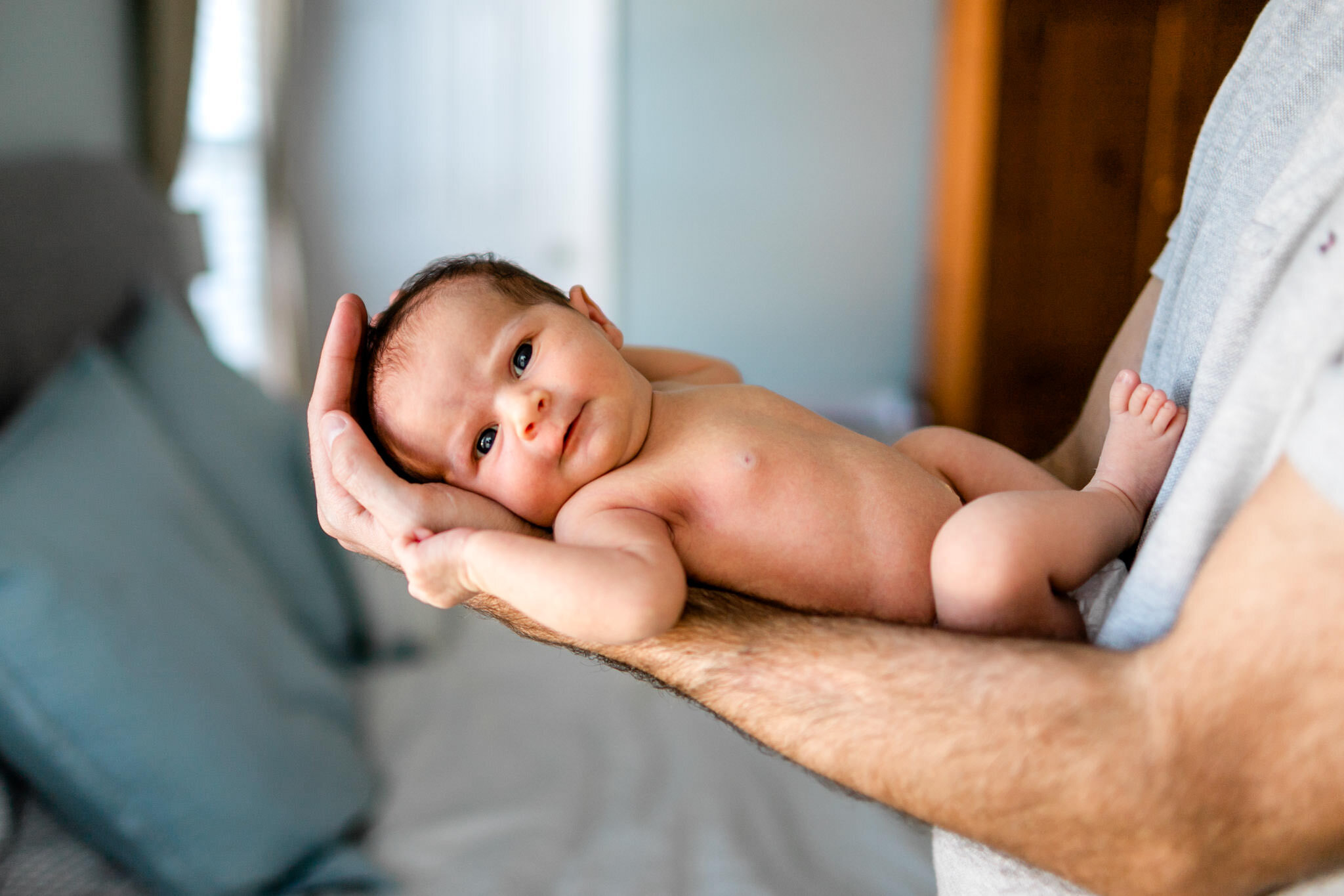 Raleigh Newborn Photographer | By G. Lin Photography | Baby girl laying on dad's arms