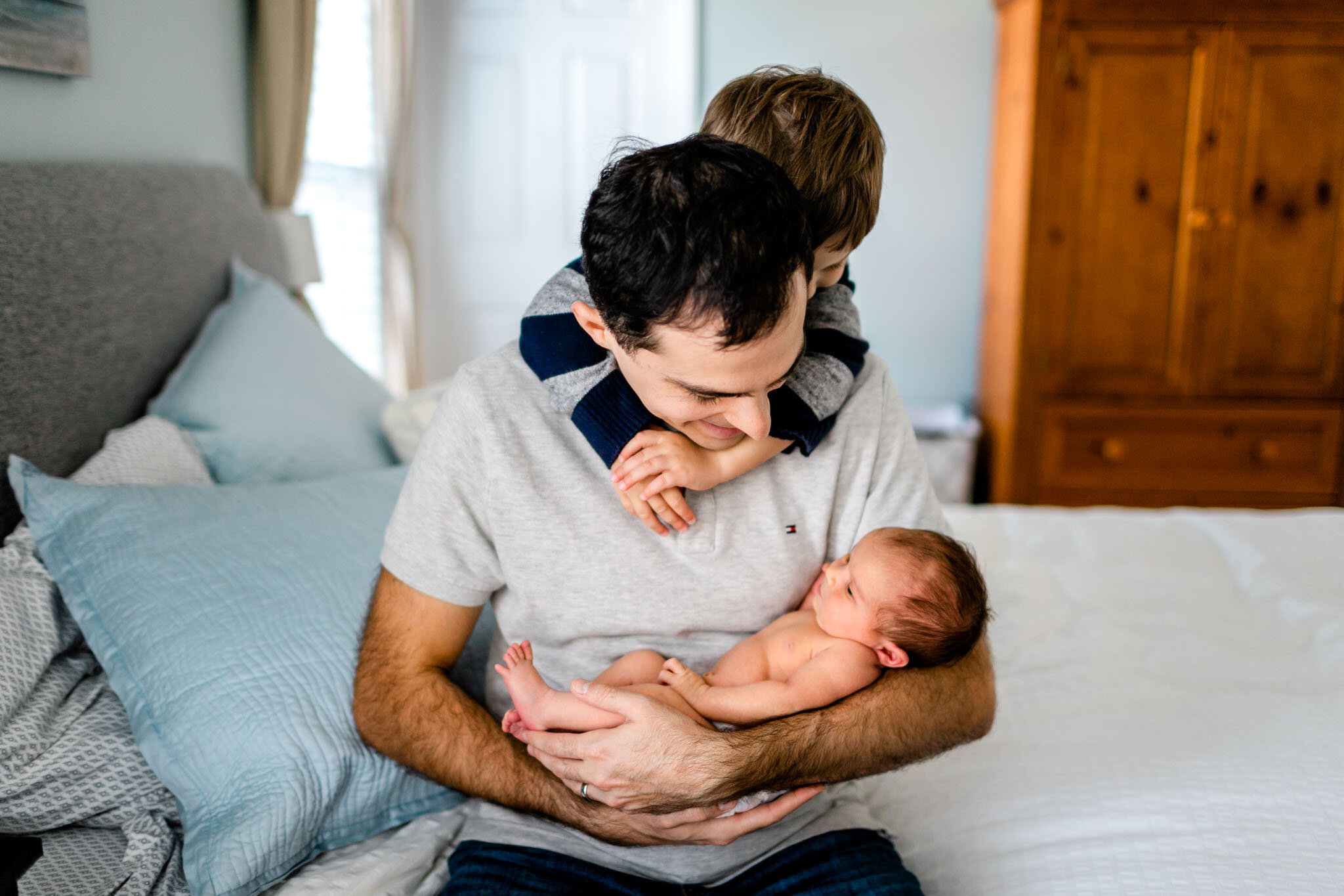Raleigh Newborn Photographer | By G. Lin Photography | Father holding baby girl and looking at her