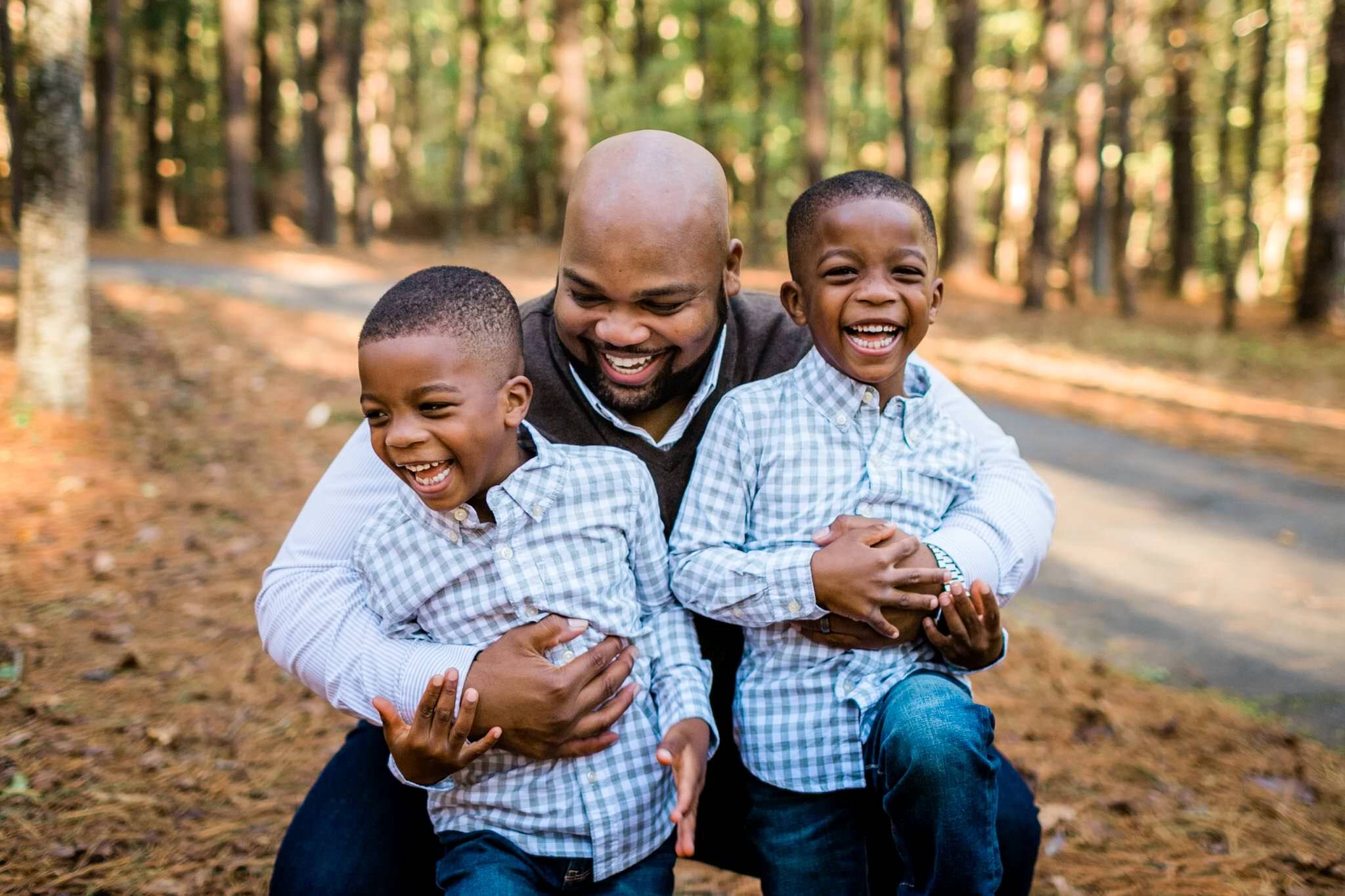 Raleigh Family Photographer | By G. Lin Photography | Umstead Park | Father hugging two identical twin boys