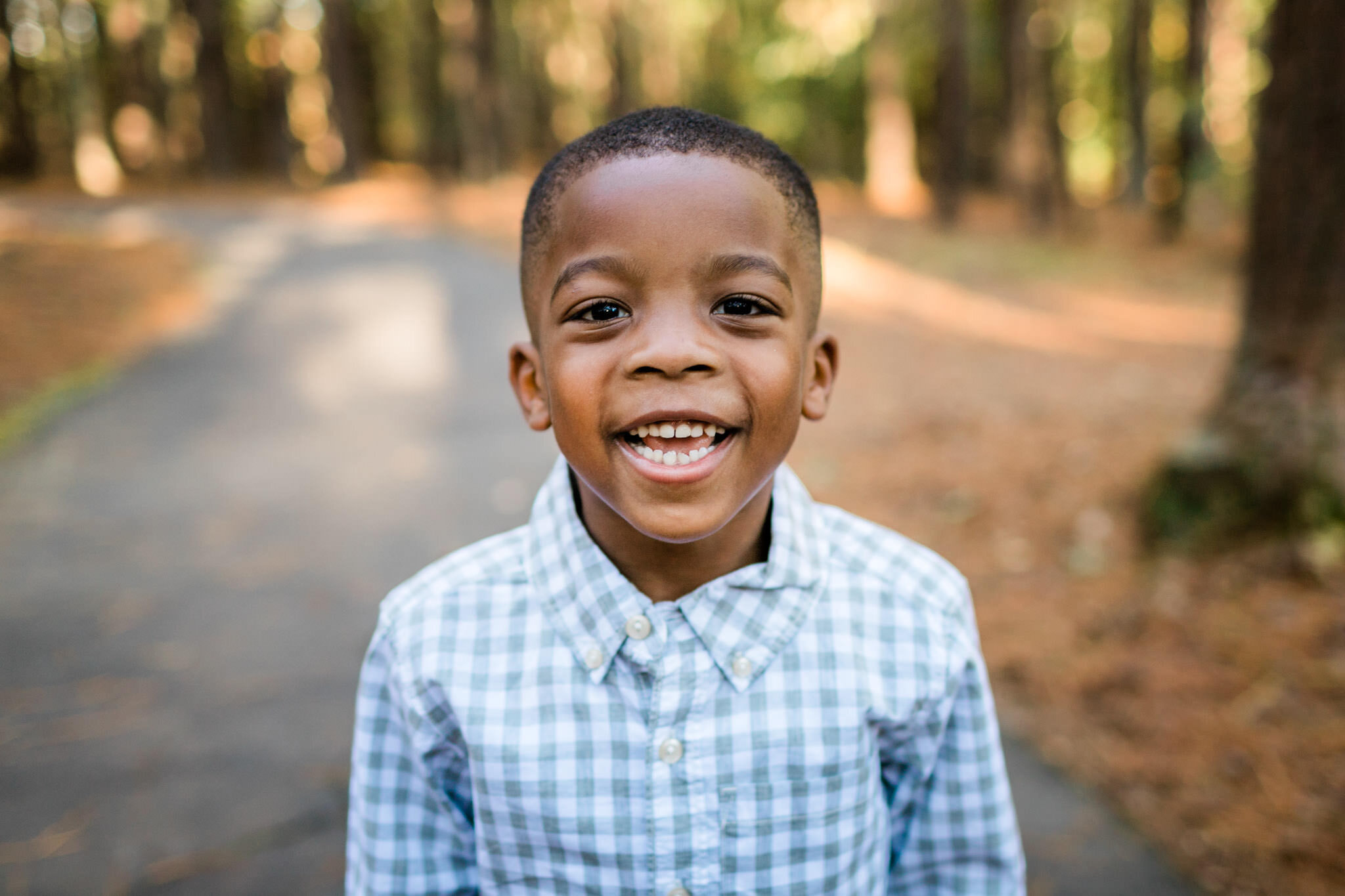 Raleigh Family Photographer | By G. Lin Photography | Umstead Park | Young boy smiling at camera