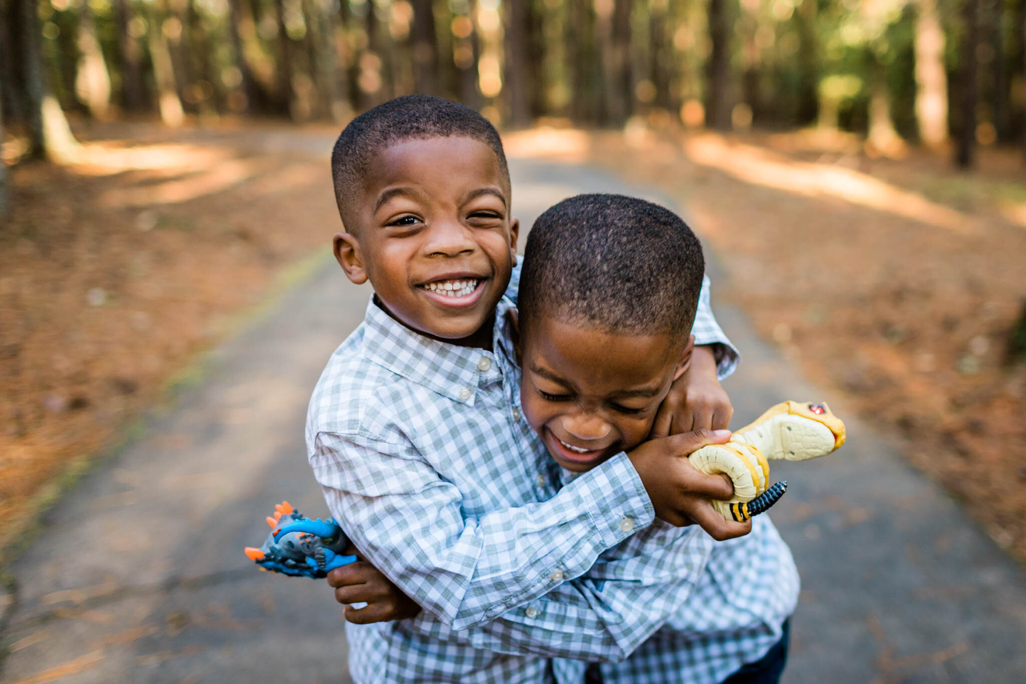 Raleigh Family Photographer | By G. Lin Photography | Umstead Park | Identical twin boys hugging one another