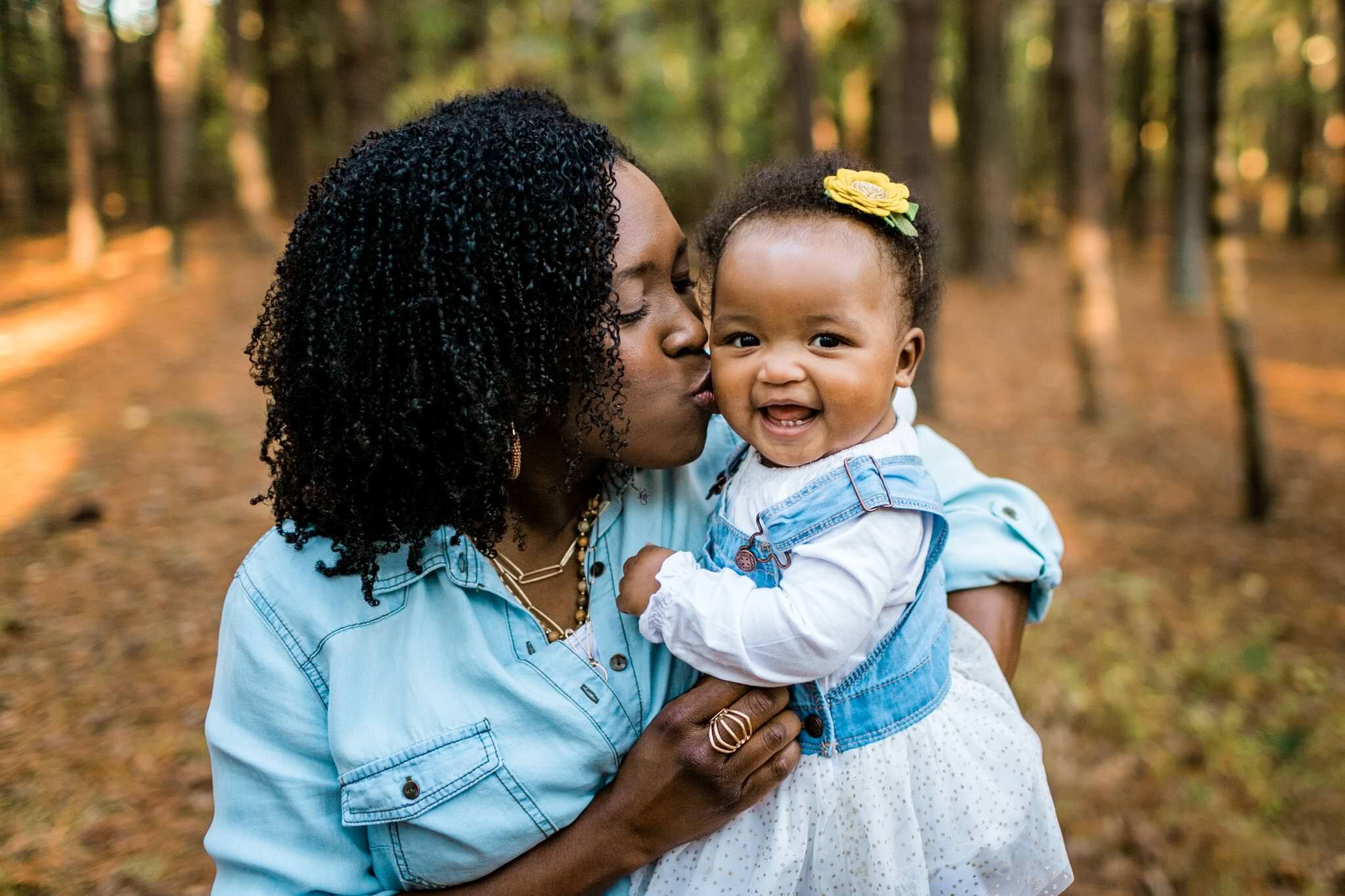 Raleigh Family Photographer | By G. Lin Photography | Umstead Park | Mother kissing baby girl on the cheek