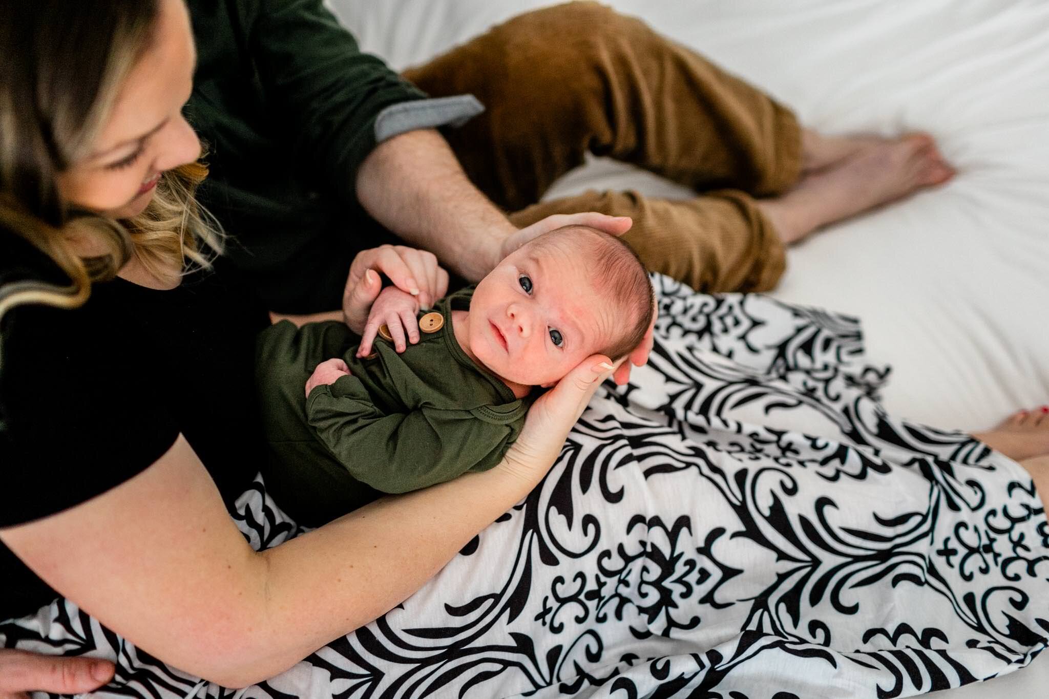 Raleigh Newborn Photographer | By G. Lin Photography | Mom holding baby boy while baby looking at the camera