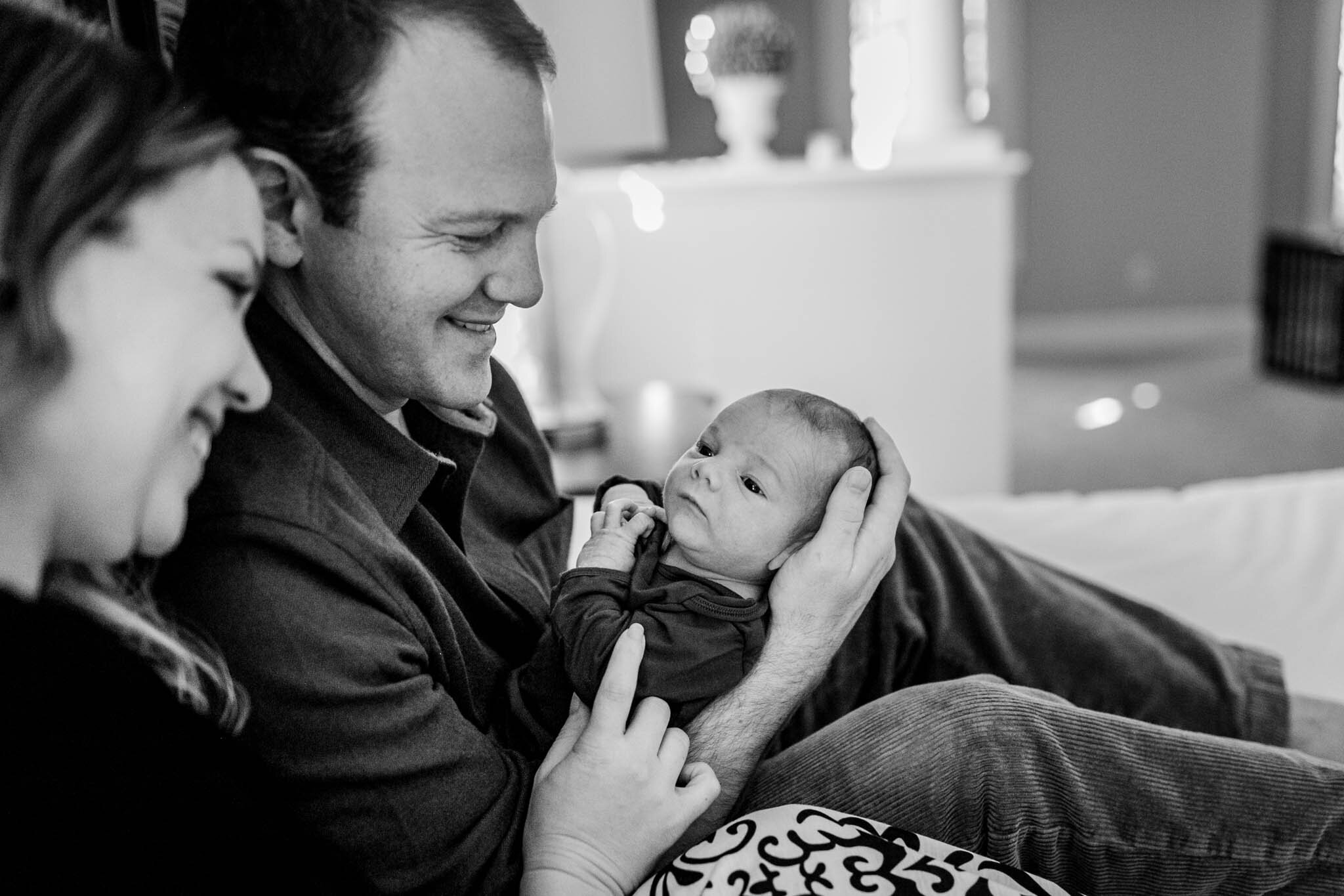 Raleigh Newborn Photographer | By G. Lin Photography | Black and white photo of mother and father holding baby