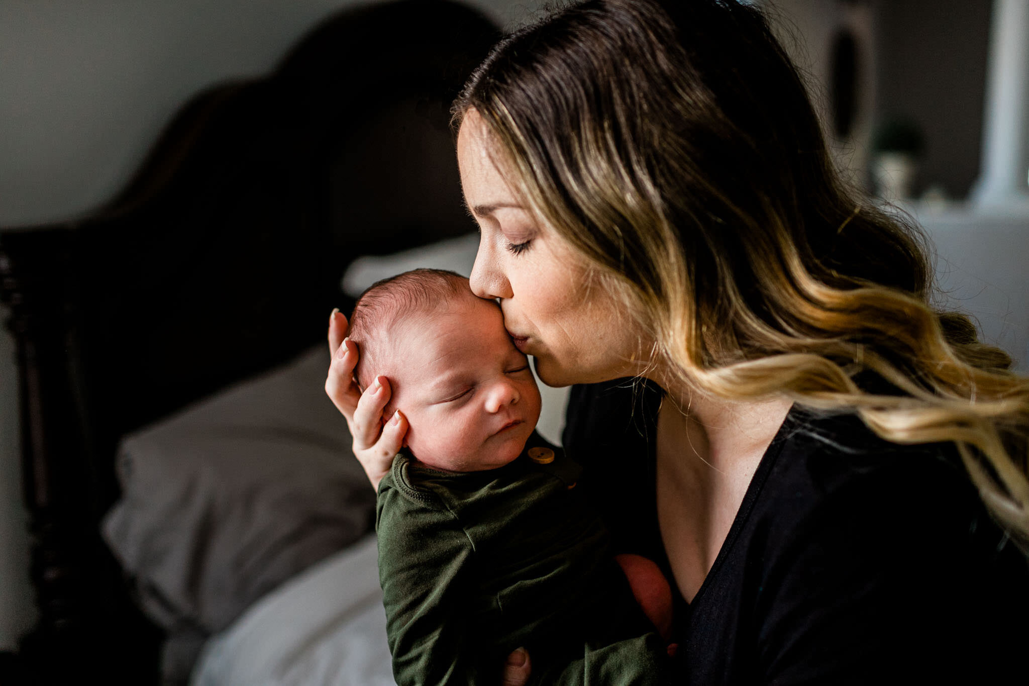 Raleigh Newborn Photographer | By G. Lin Photography | Mother kissing baby boy on the head