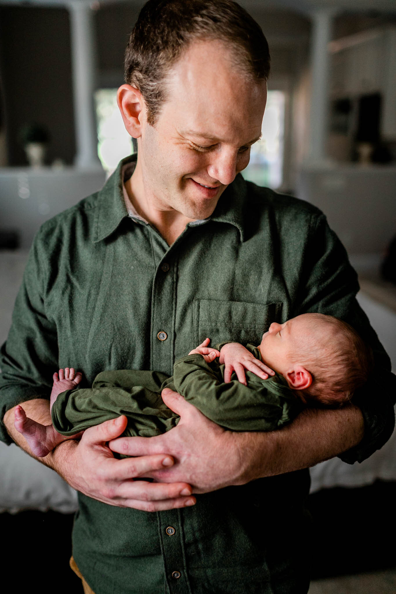 Raleigh Newborn Photographer | By G. Lin Photography | Father looking at baby boy in his arms