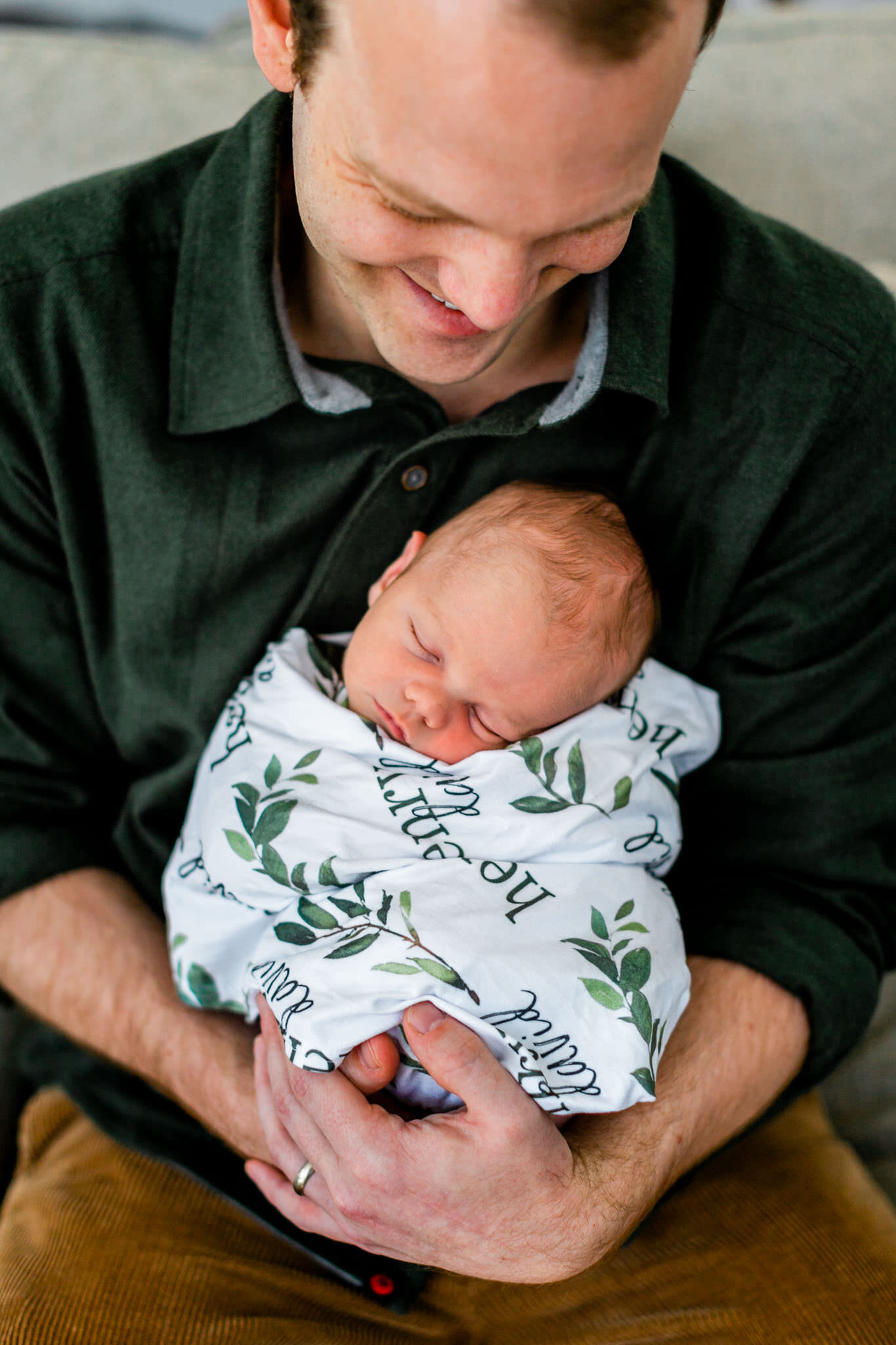 Raleigh Newborn Photographer | By G. Lin Photography | Dad holding baby in his lap
