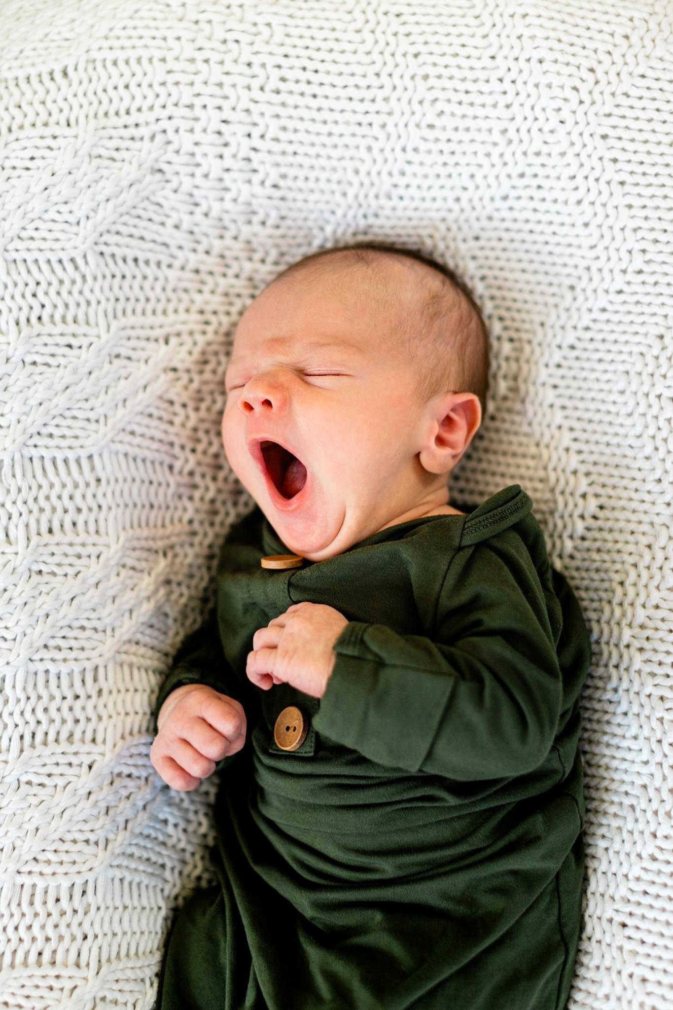 Raleigh Newborn Photographer | By G. Lin Photography | Baby yawning and laying on white blanket