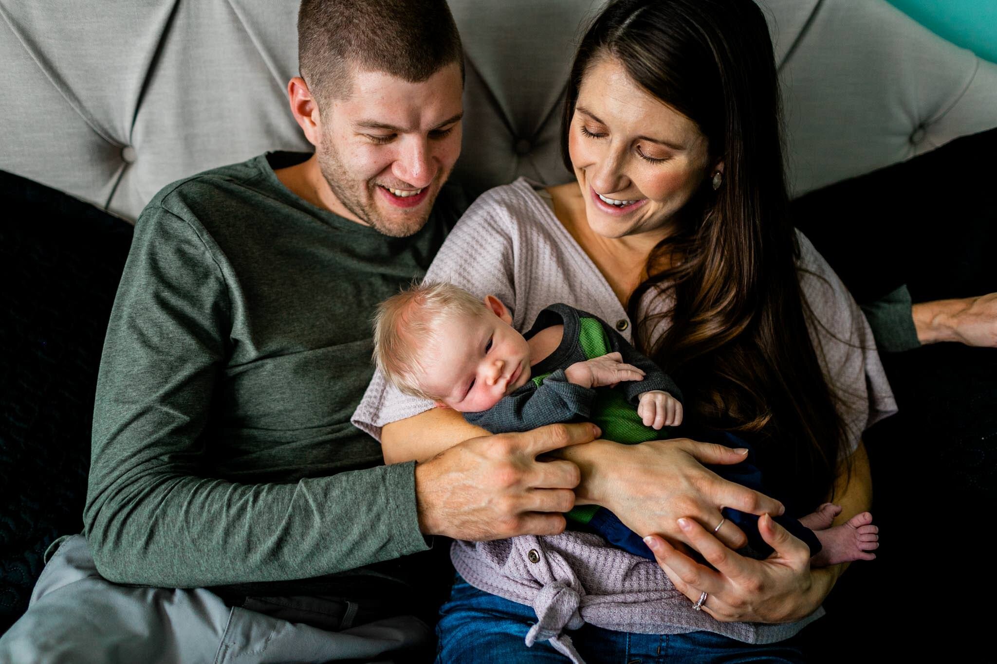 Durham Newborn Photographer | By G. Lin Photography | Mother and father holding baby on bed