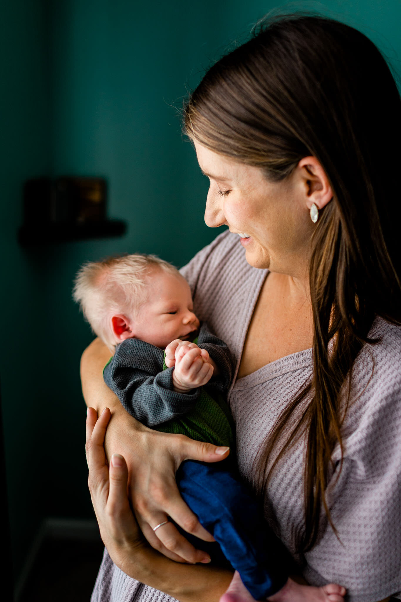 Durham Newborn Photographer | By G. Lin Photography | Mother holding baby boy by the window light