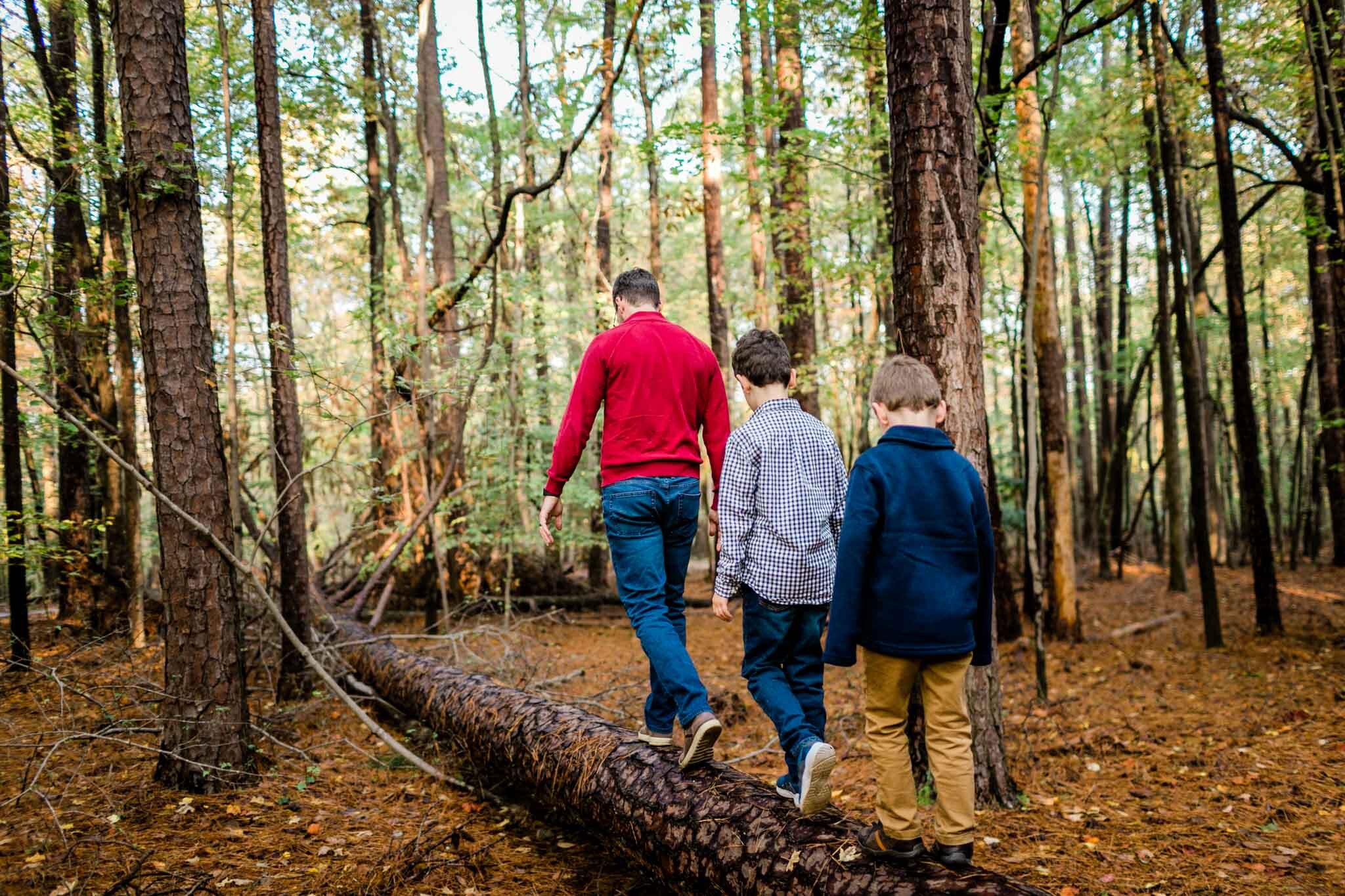 Raleigh Family Photographer | By G. Lin Photography | Umstead Park | Dad and two sons walking on log