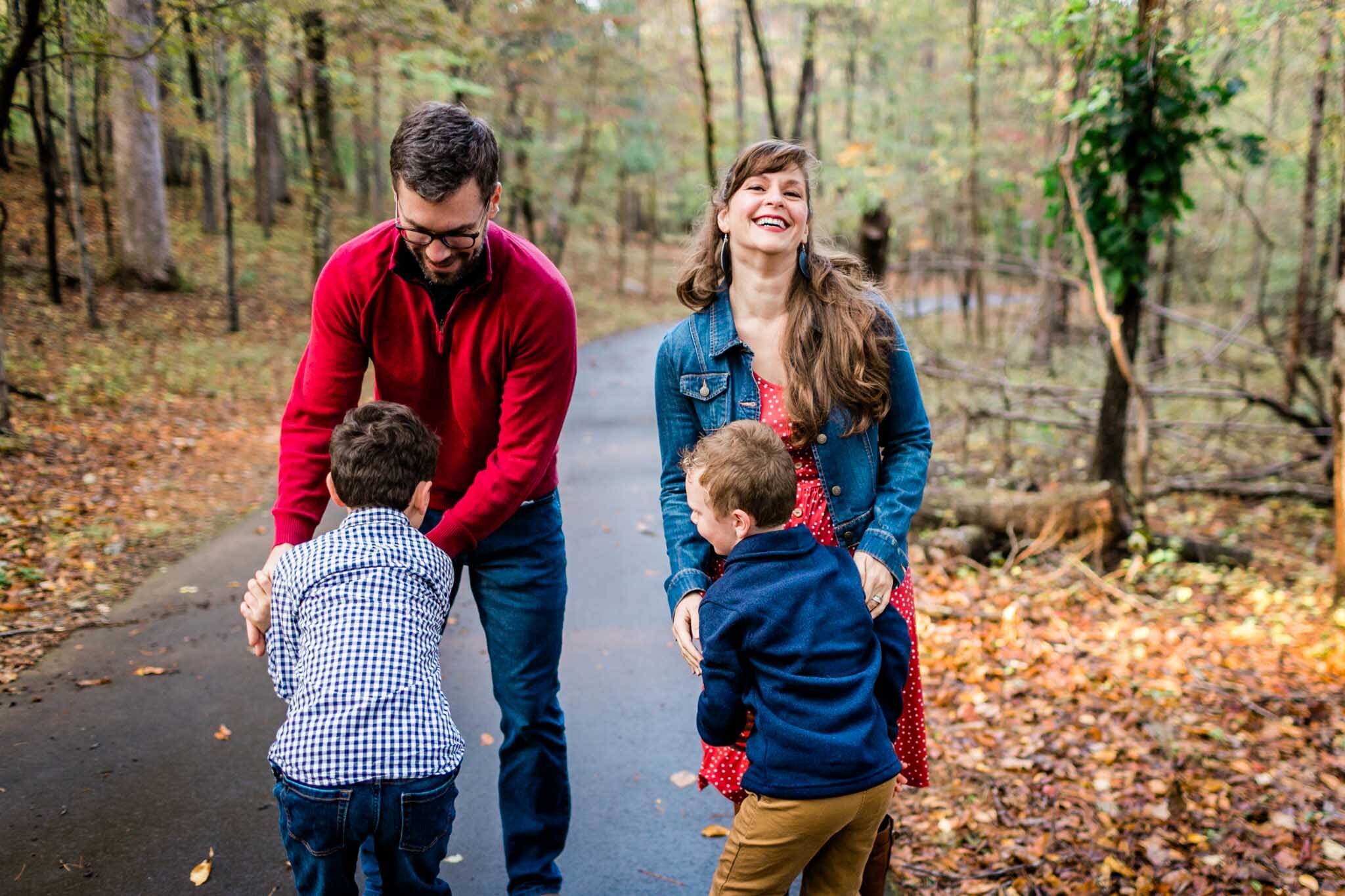 Raleigh Family Photographer | By G. Lin Photography | Umstead Park | Mom and dad playing with their two sons