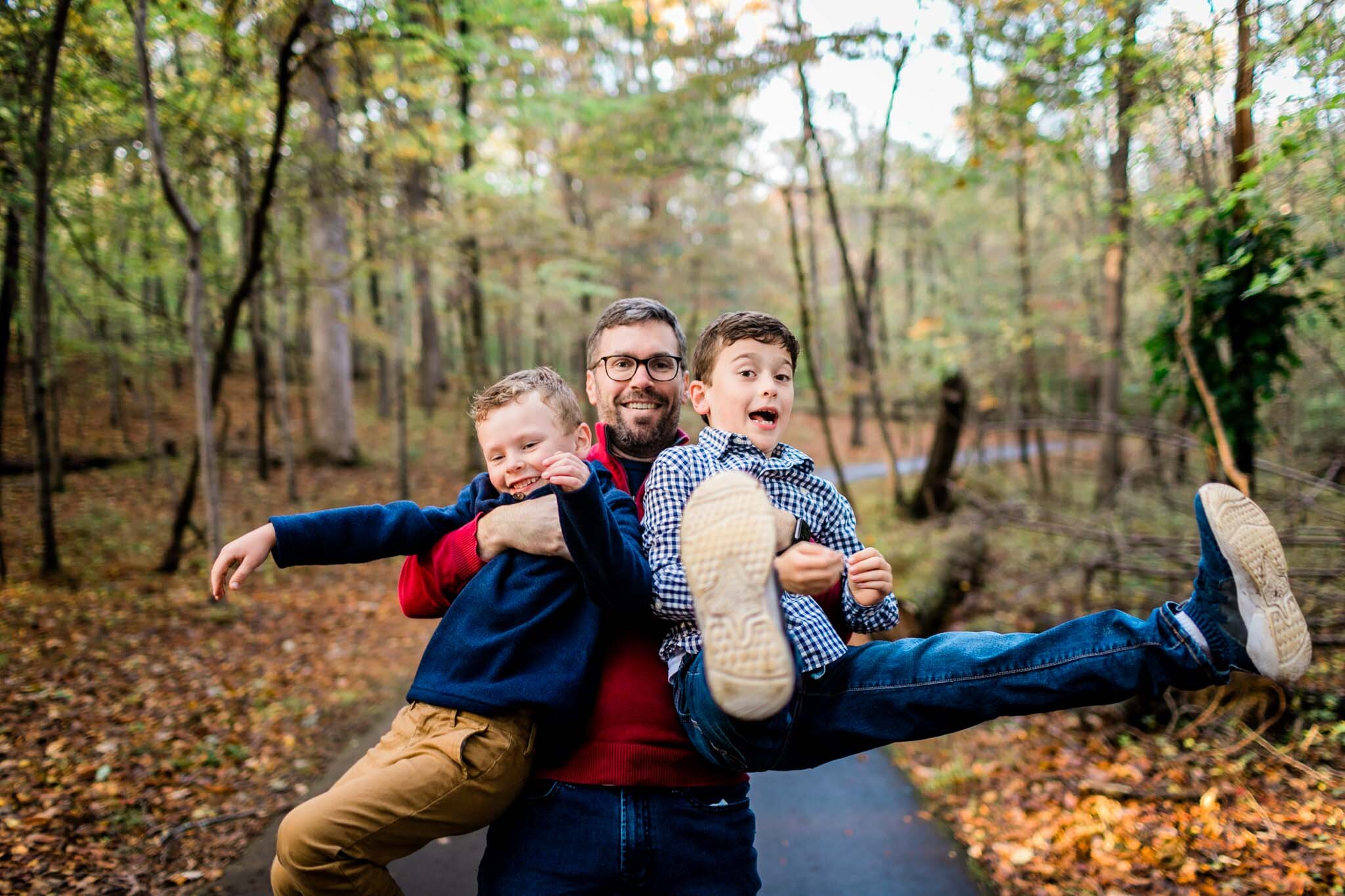 Raleigh Family Photographer | By G. Lin Photography | Umstead Park | Dad holding two sons in his arms