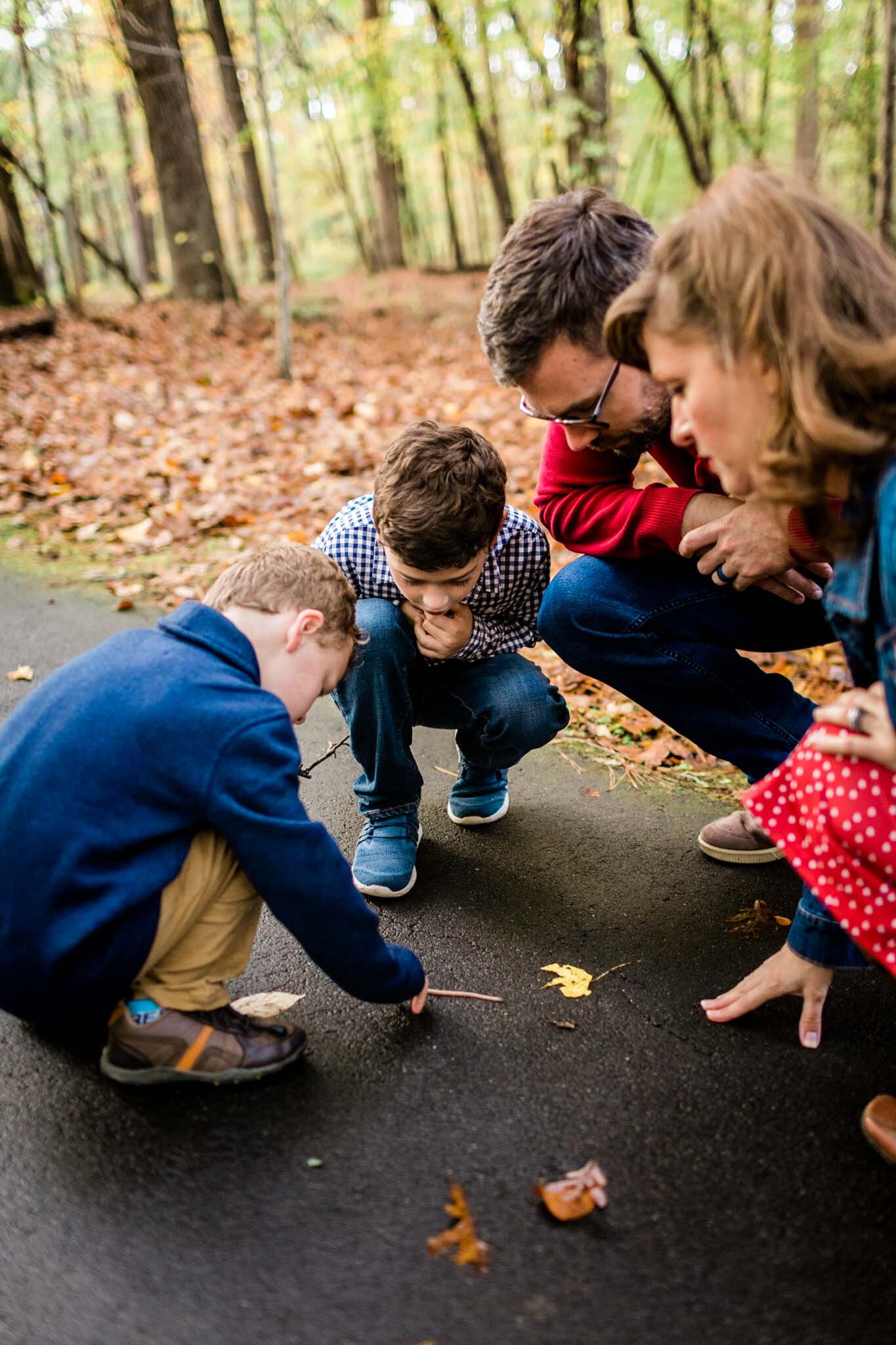 Raleigh Family Photographer | By G. Lin Photography | Umstead Park | Family looking at earthworm