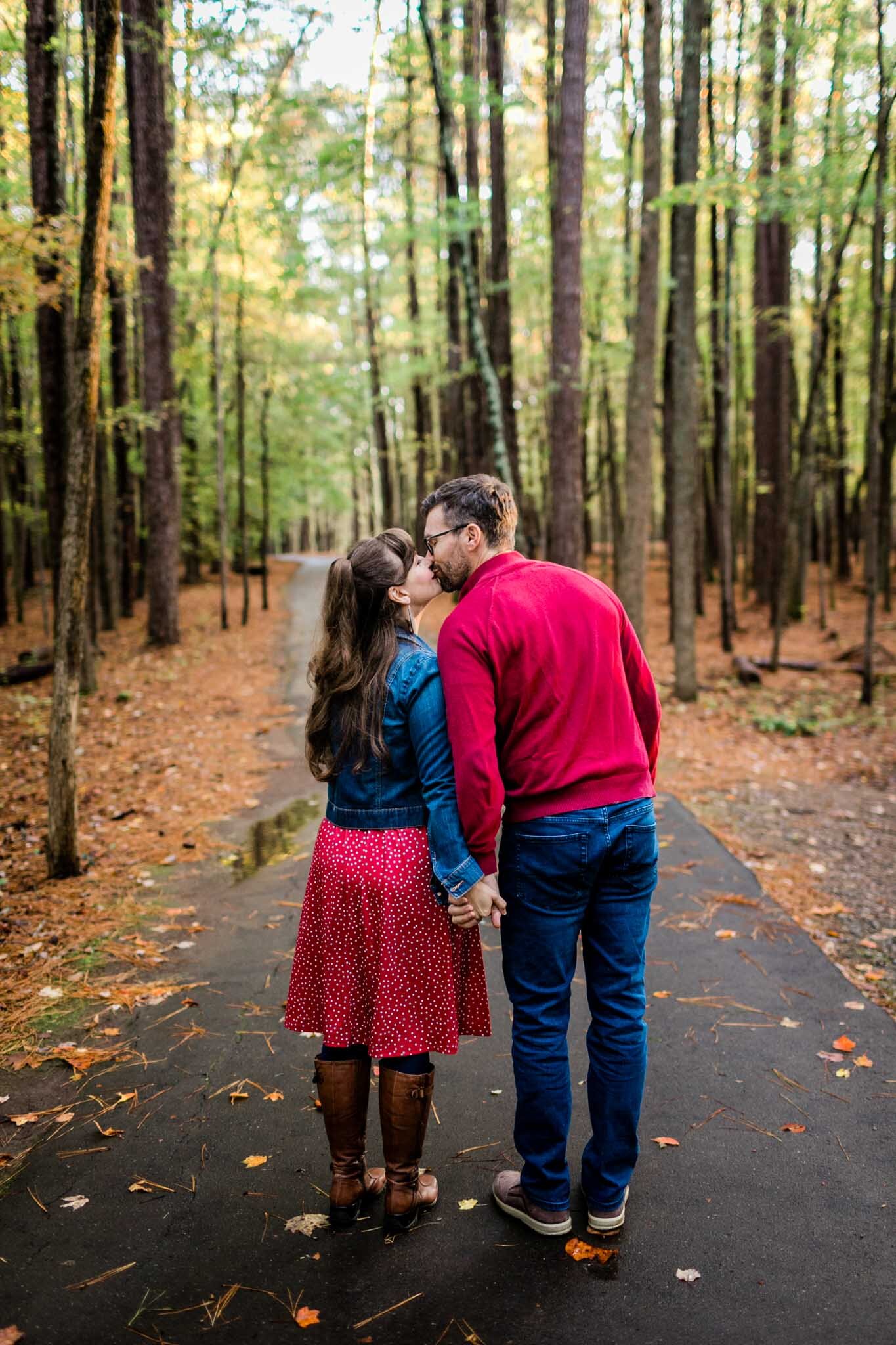 Raleigh Family Photographer | By G. Lin Photography | Umstead Park | Husband and wife kissing outdoors in forest