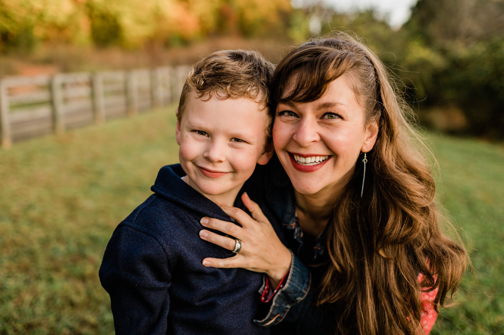 Raleigh Family Photographer | By G. Lin Photography | Umstead Park | Mother hugging son outdoor candid portrait