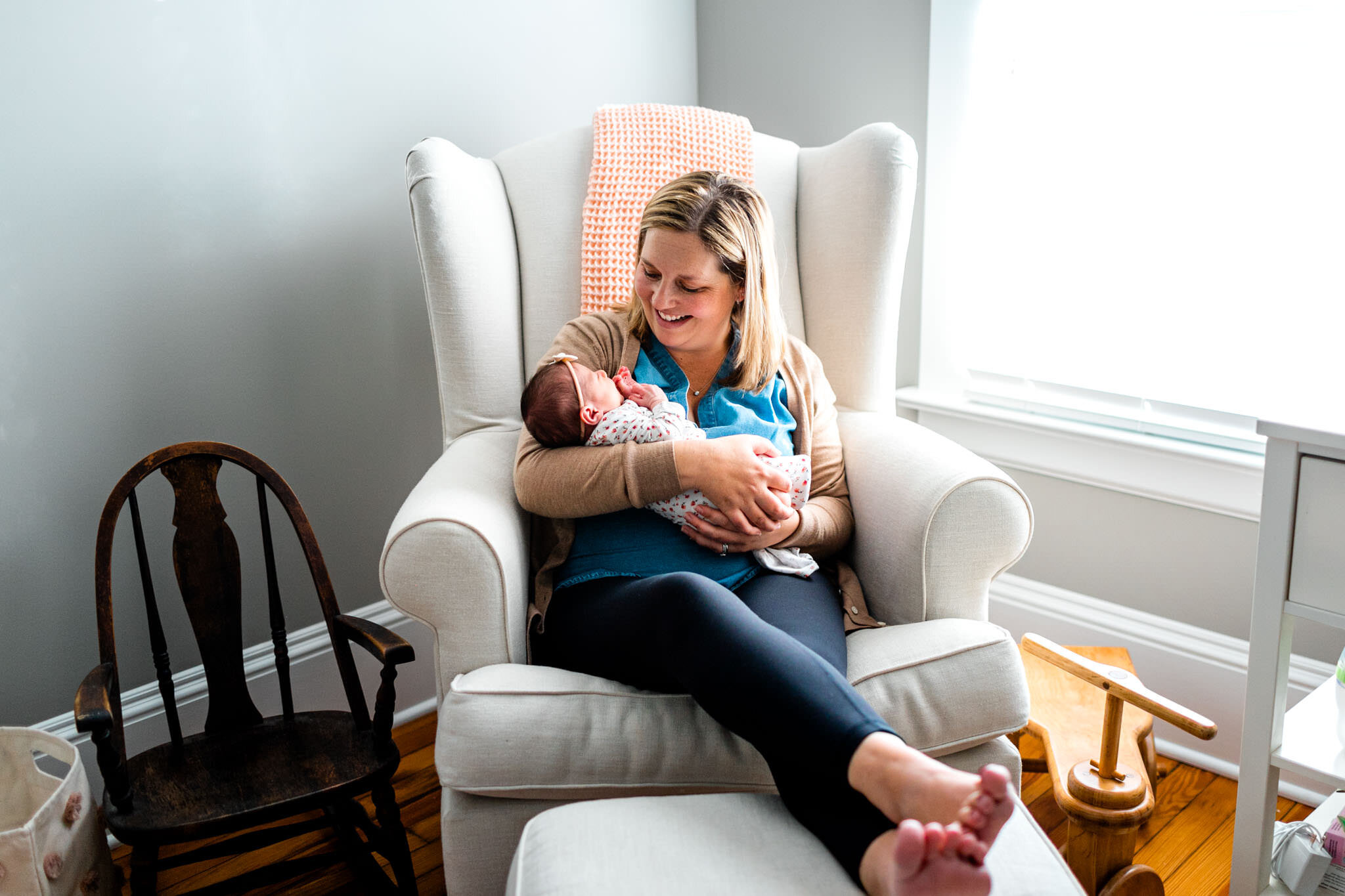 Durham Newborn Photographer | By G. Lin Photography | Mother holding baby by window