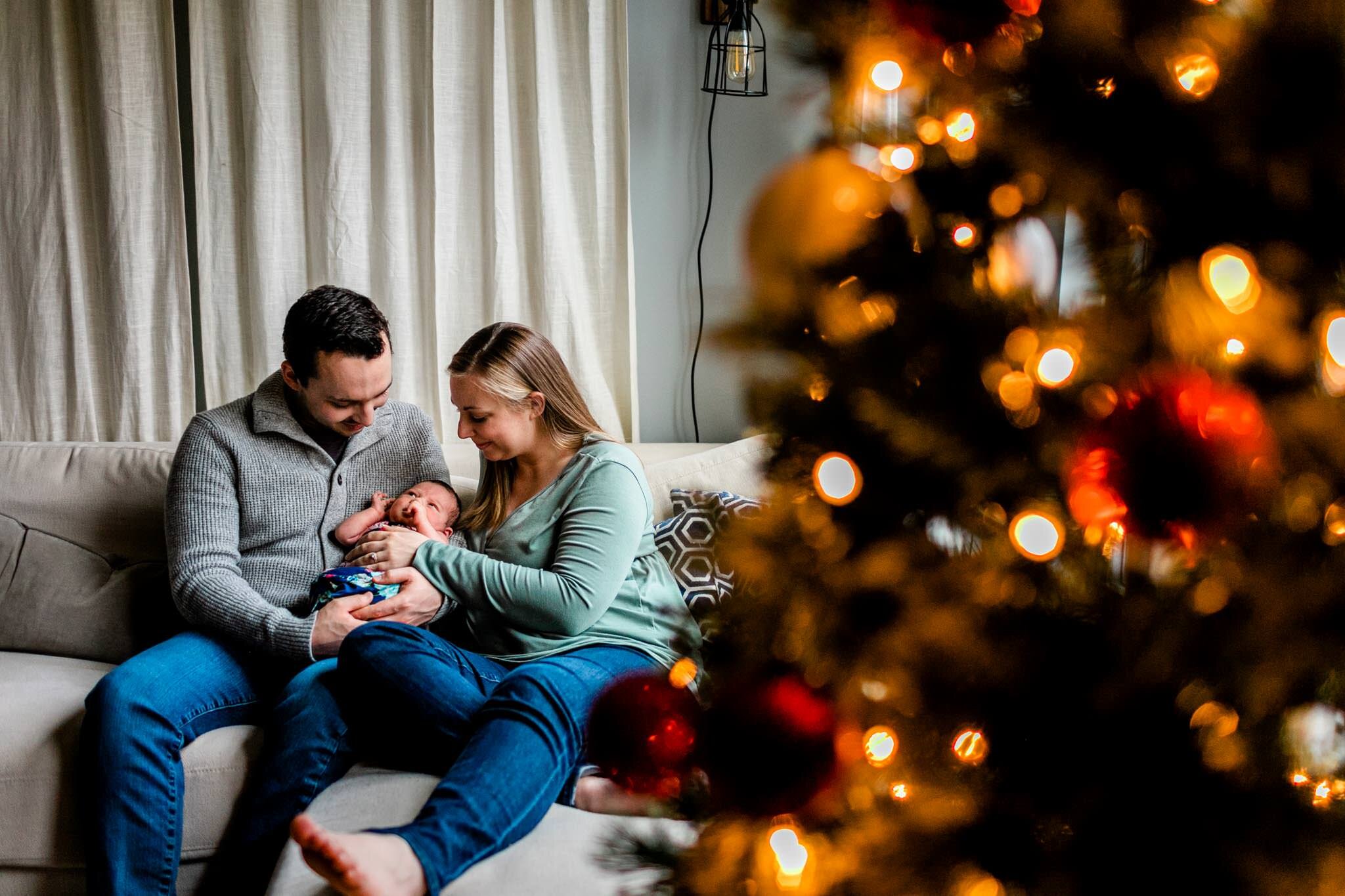 Durham Newborn Photographer | By G. Lin Photography | Family sitting on couch by Christmas tree