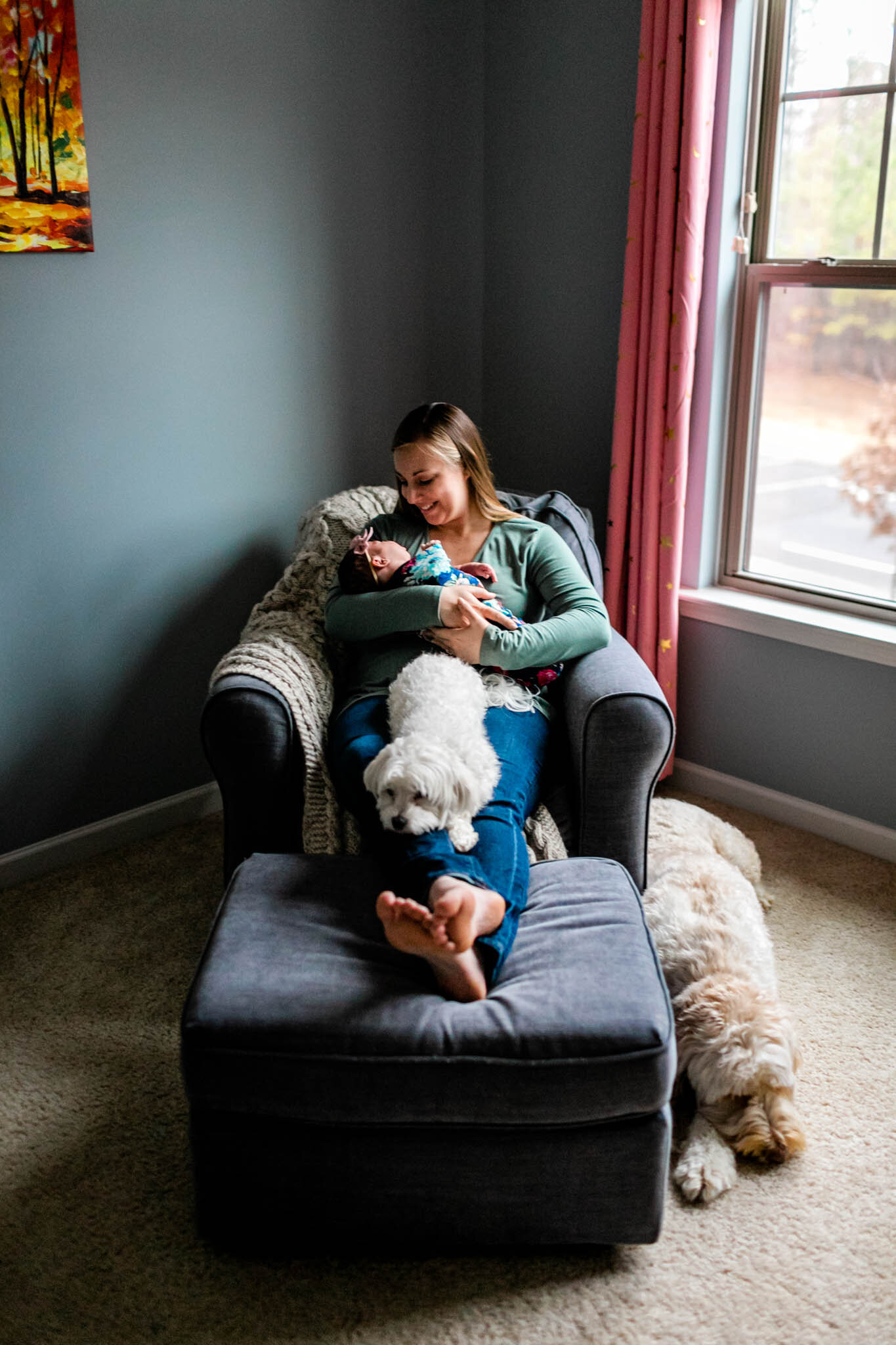 Durham Newborn Photographer | By G. Lin Photography | Candid portrait of mom in nursery with baby and dogs