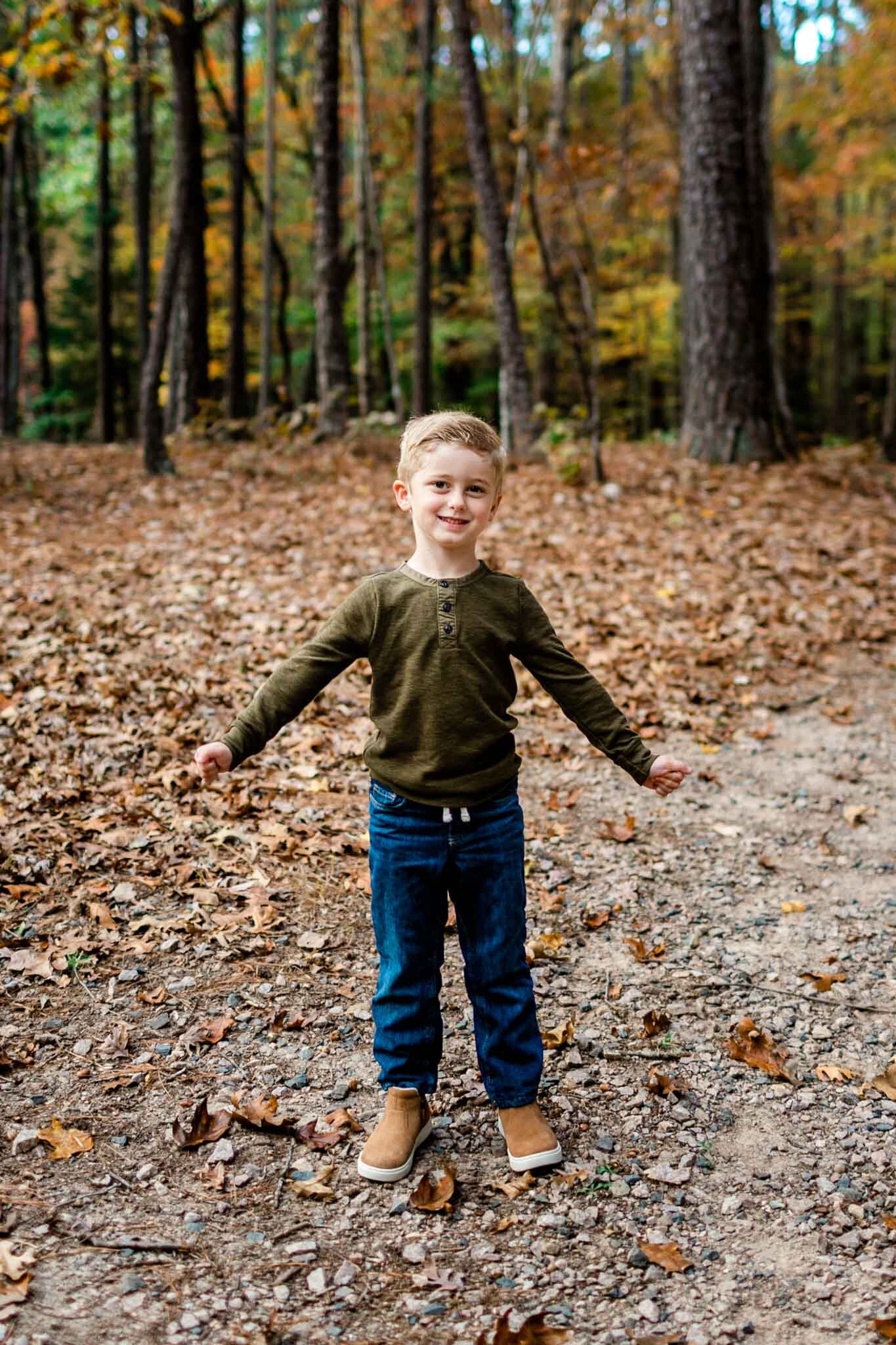 Raleigh Family Photographer at Umstead Park | By G. Lin Photography | Young boy smiling with arms out