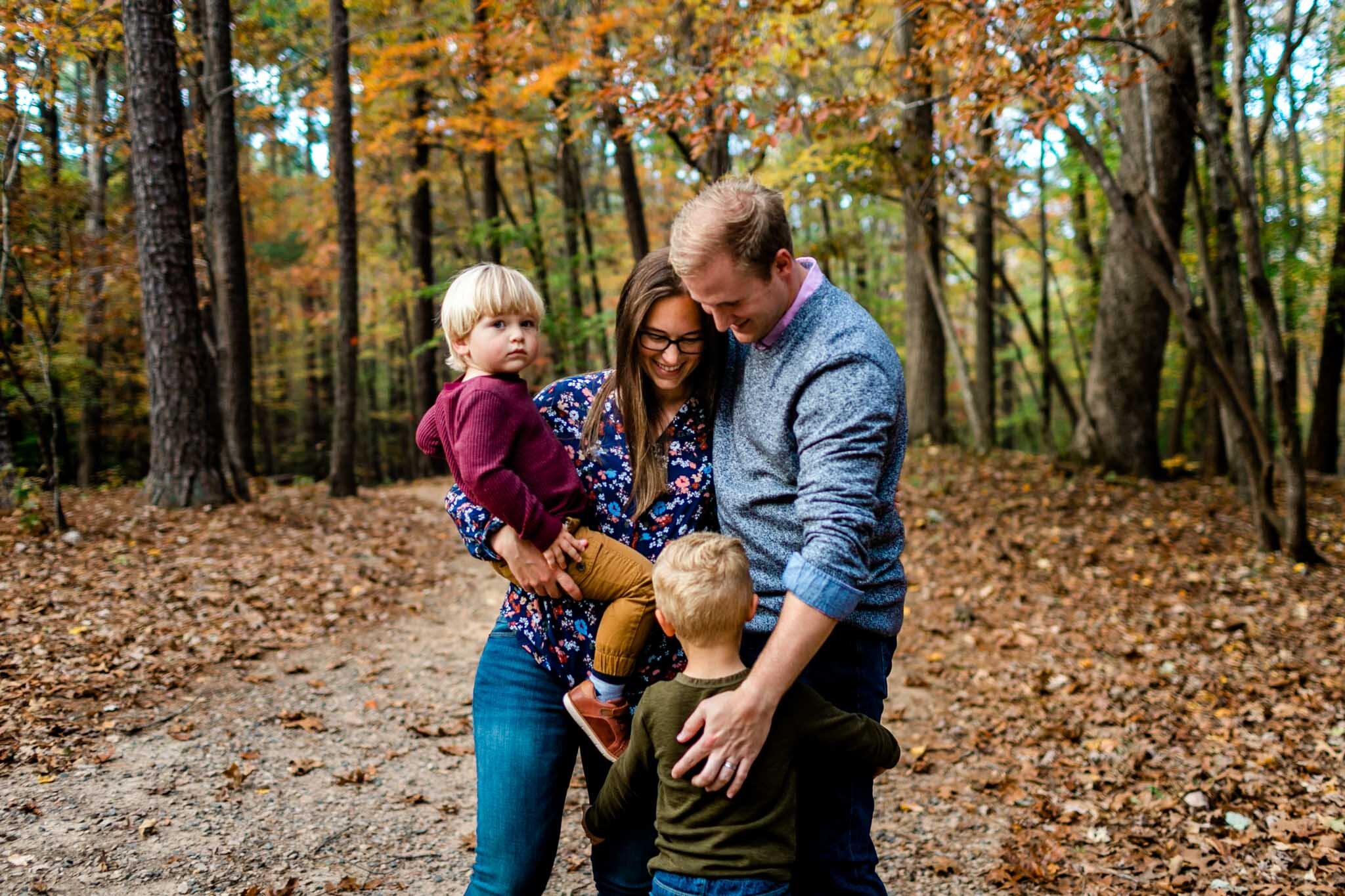 Raleigh Family Photographer at Umstead Park | By G. Lin Photography | Family of four standing together among trees