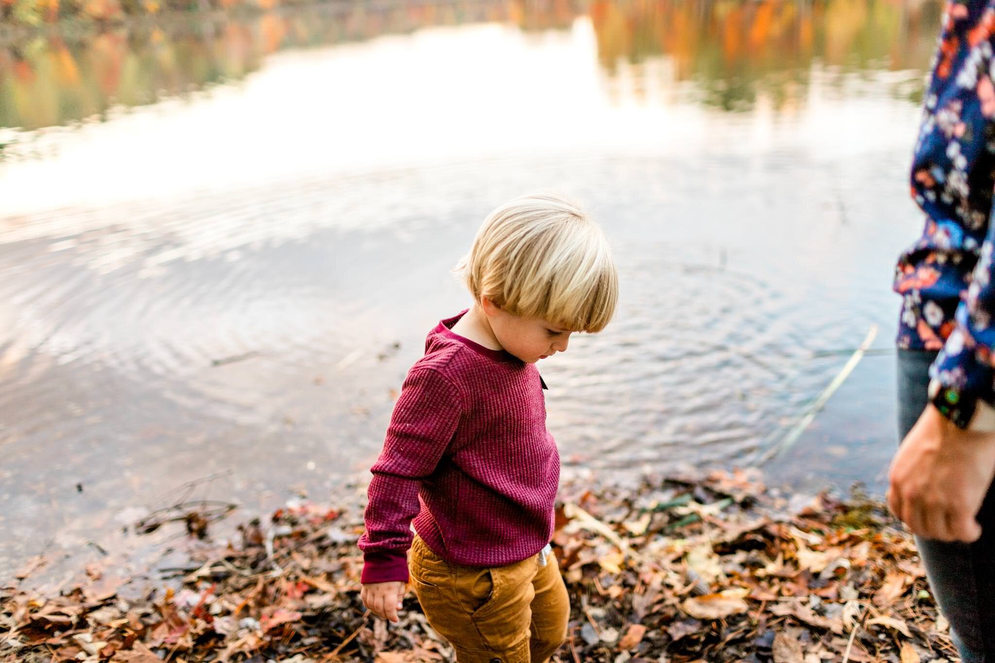 Raleigh Family Photographer at Umstead Park | By G. Lin Photography | Young boy in red shirt standing by lake
