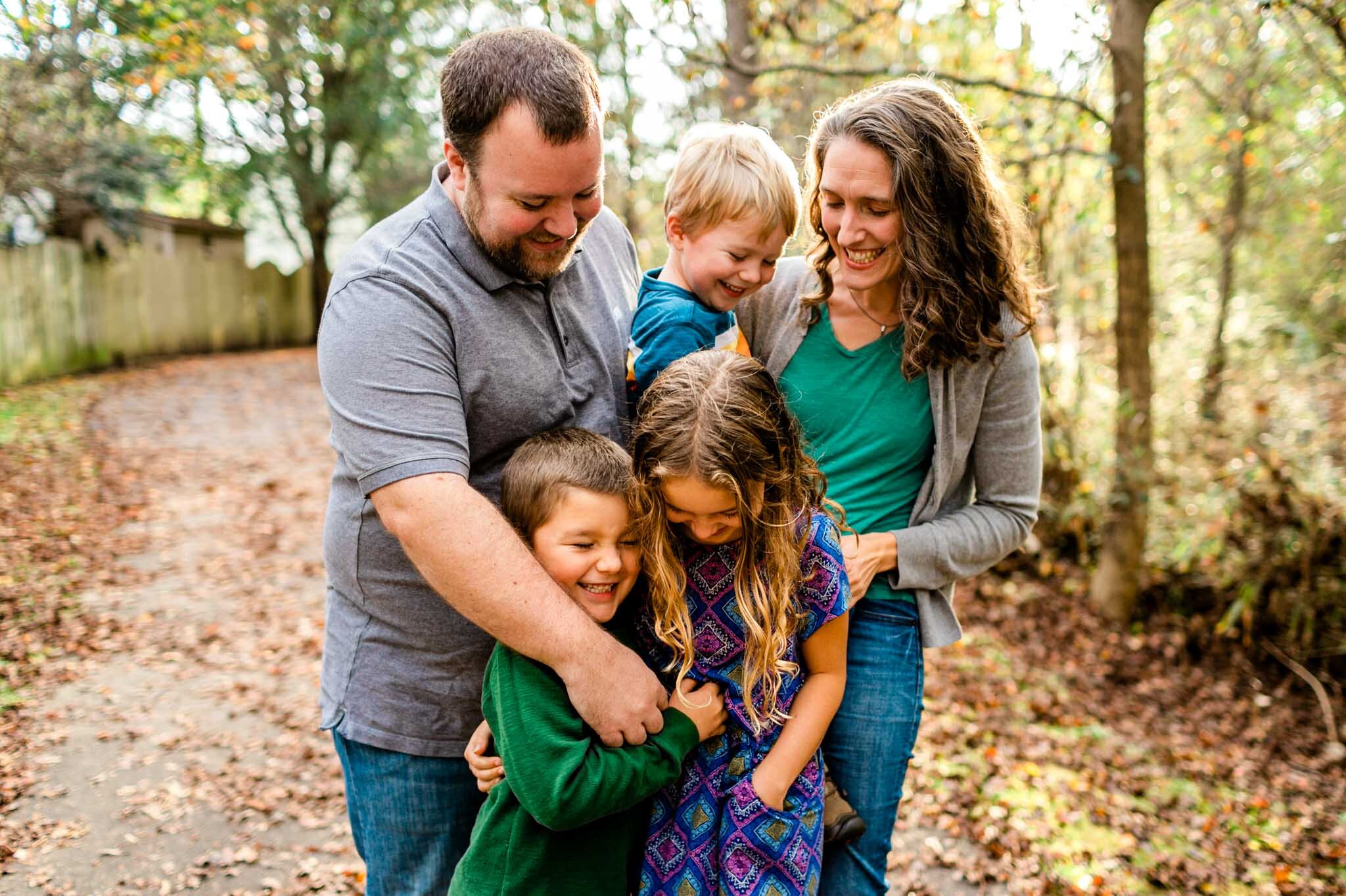 Apex Family Photographer | By G. Lin Photography | Family laughing and hugging one another