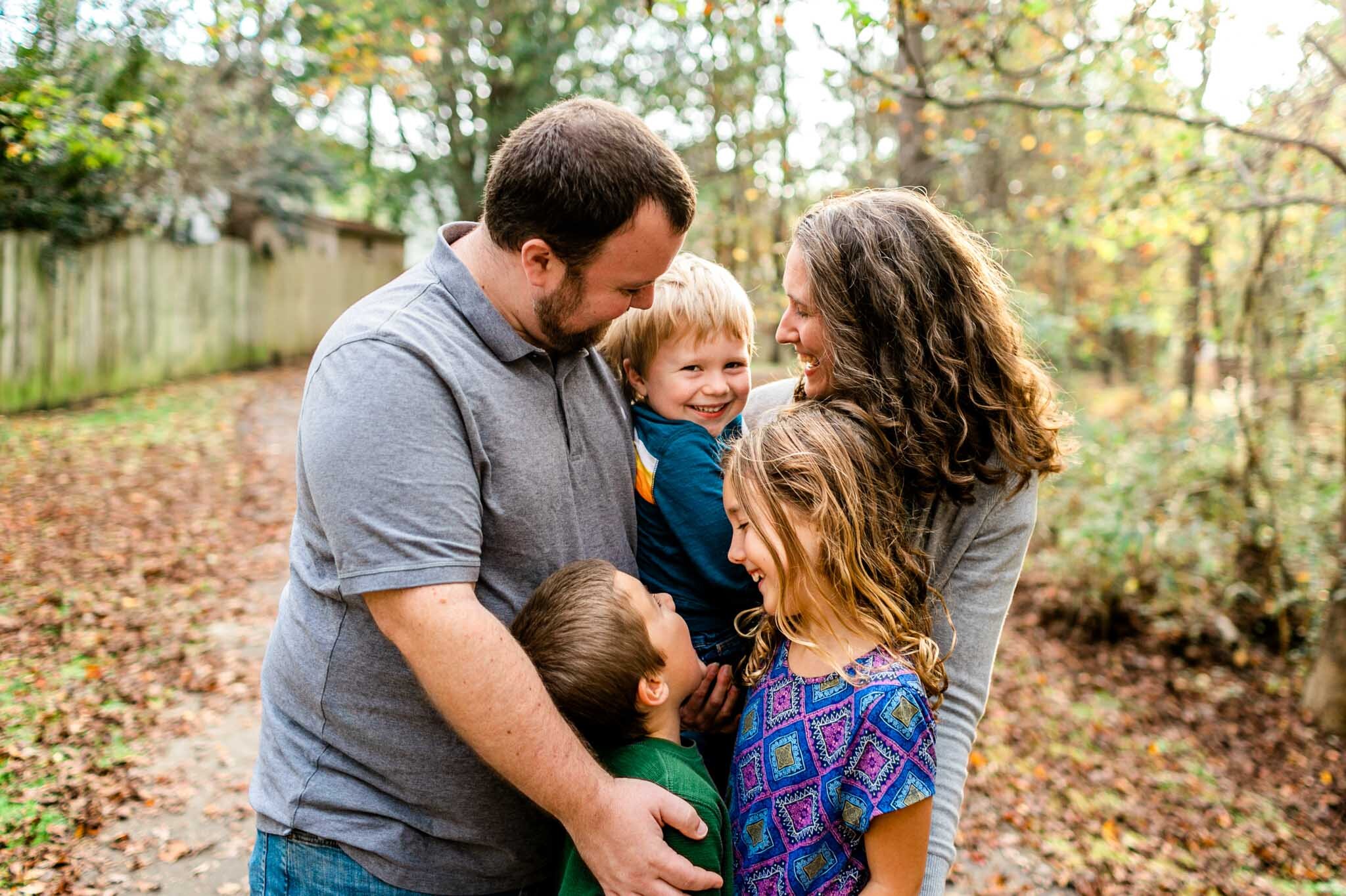 Apex Family Photographer | By G. Lin Photography | Candid family photo with mom holding toddler boy