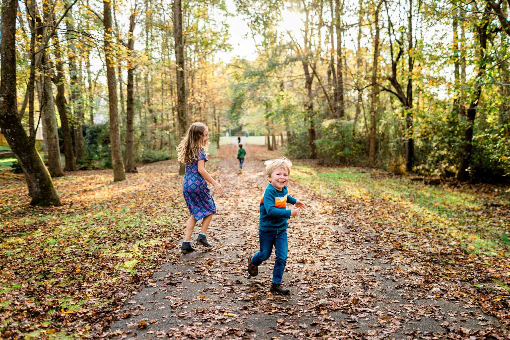 Apex Family Photographer | By G. Lin Photography | Children running on leaves