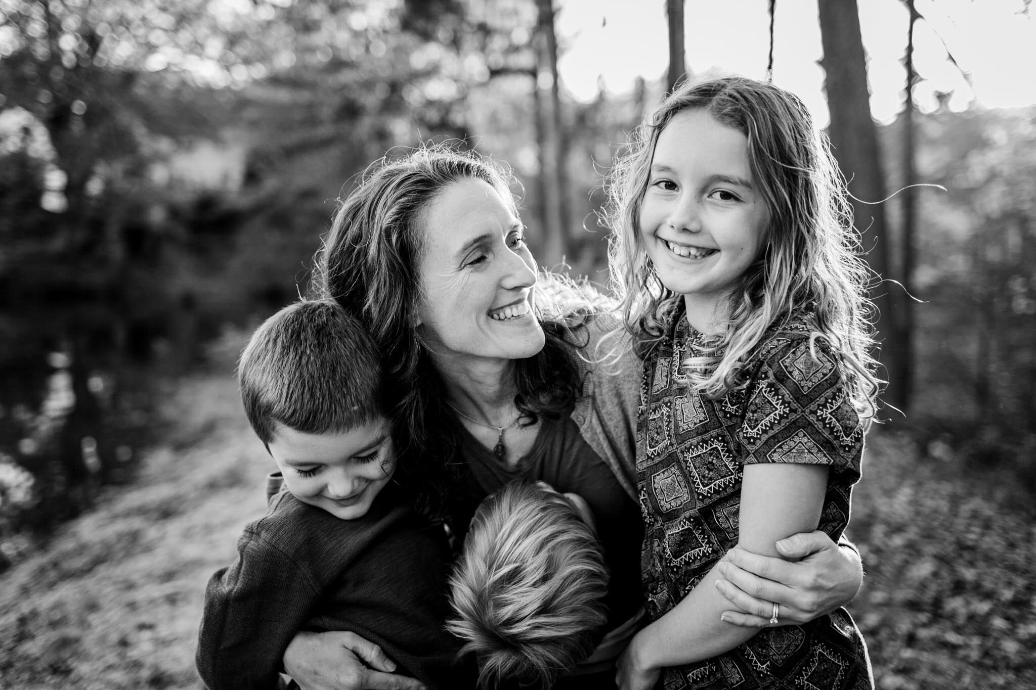 Apex Family Photographer | By G. Lin Photography | Black and white image of mom embracing her kids