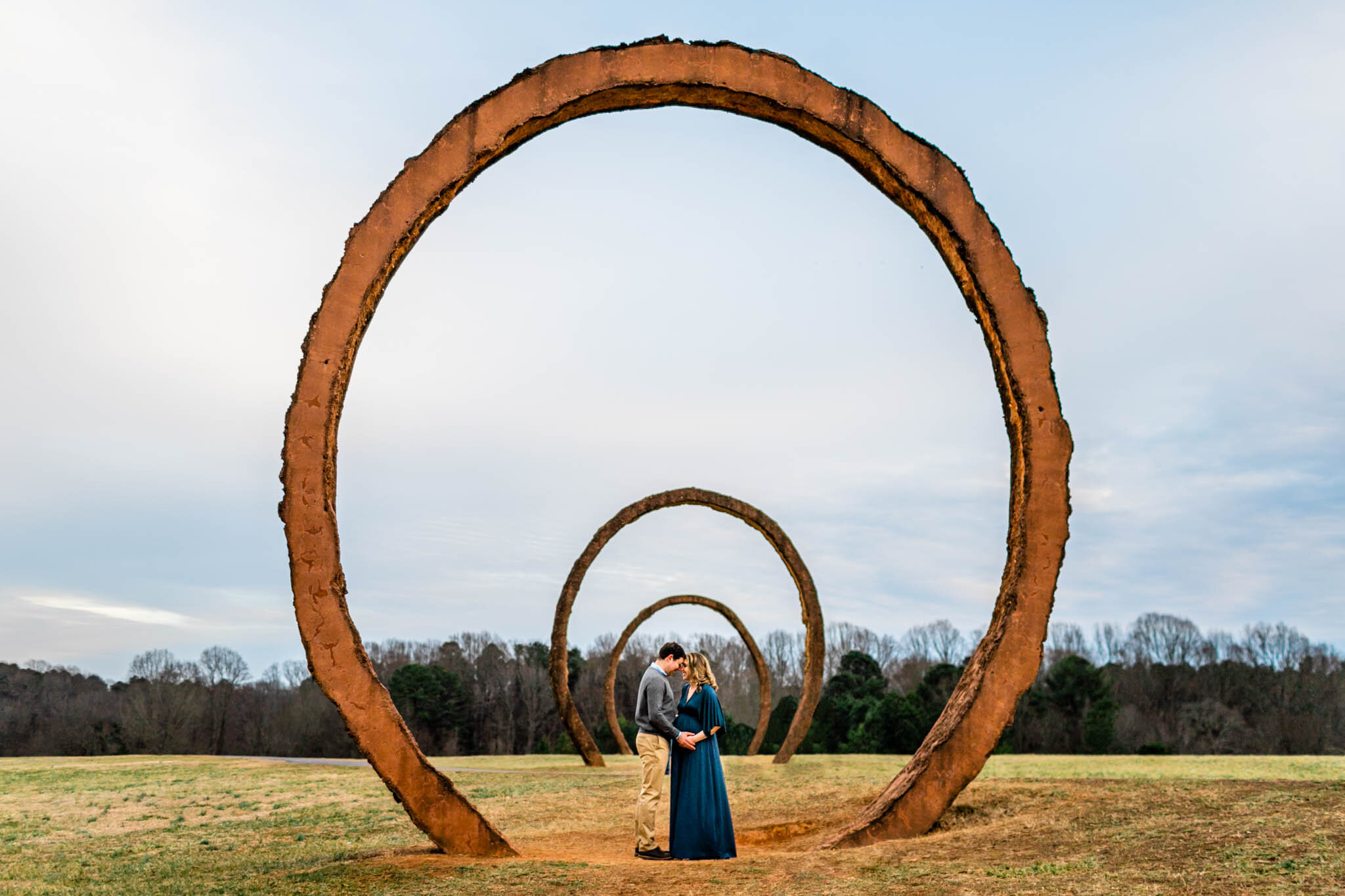 Raleigh Newborn Photographer | G. Lin Photography | NCMA | Couple standing in the middle of orange rings