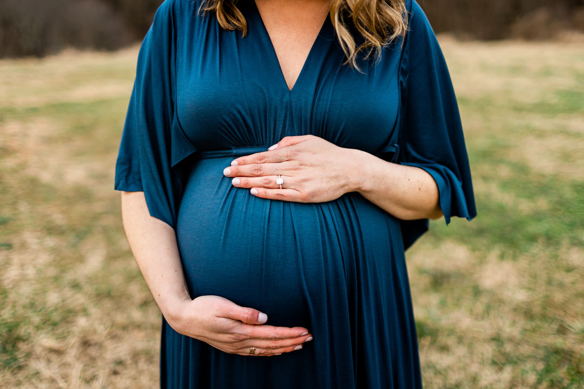 Raleigh Newborn Photographer | By G. Lin Photography | Maternity portrait of woman's hands touching baby bump