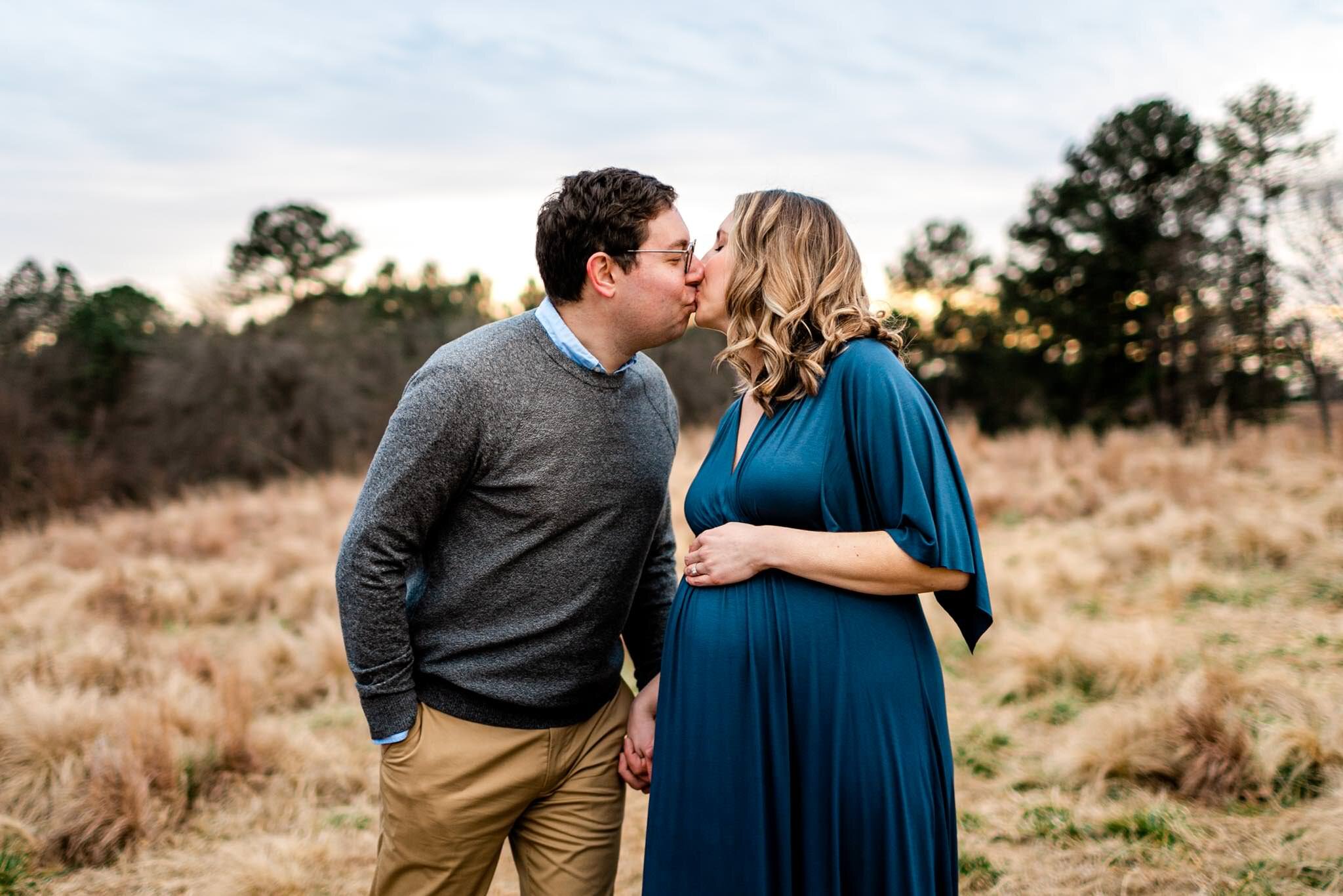 Raleigh Newborn Photographer | By G. Lin Photography | Couple kissing in open field at NCMA