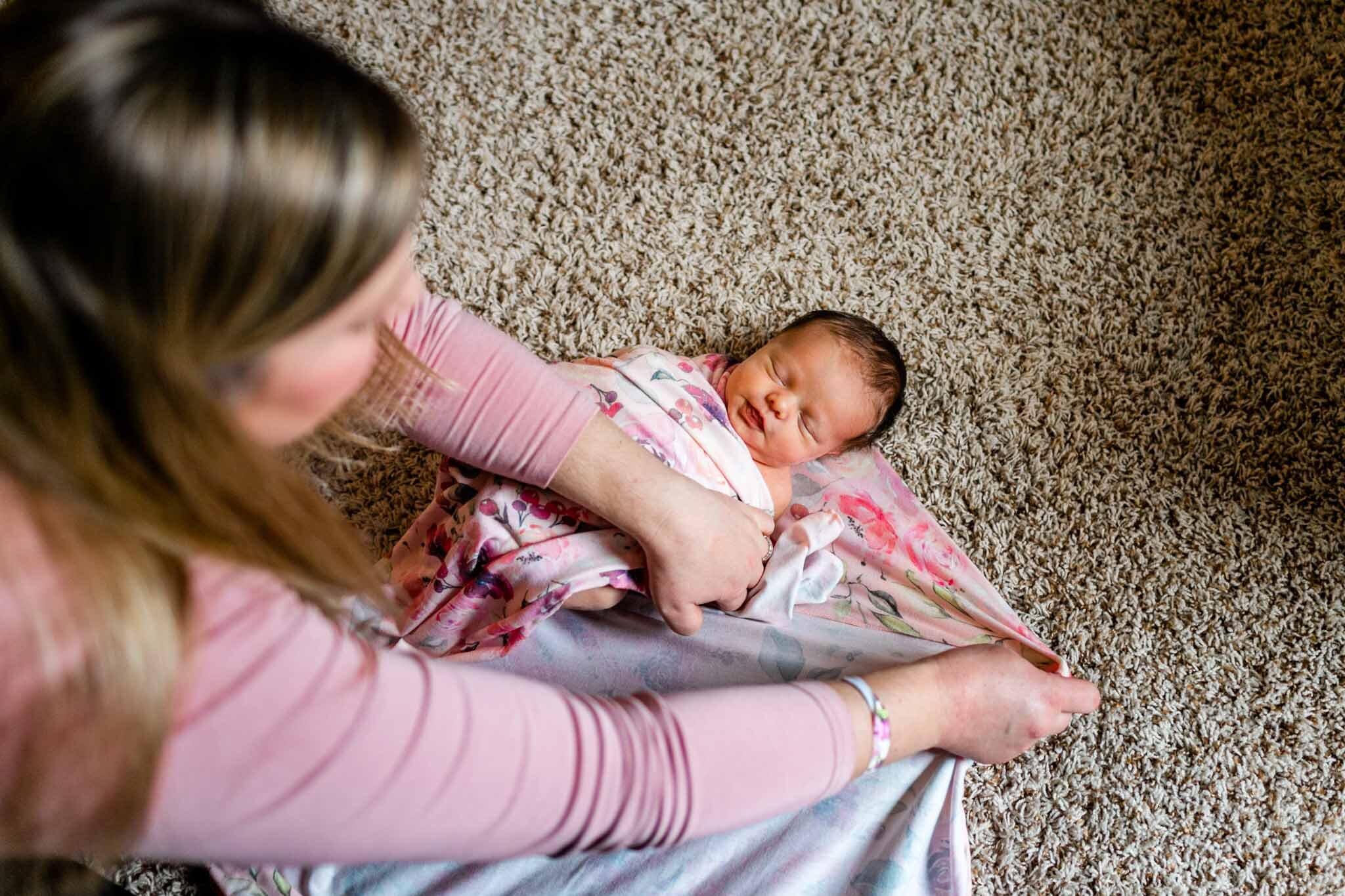 Raleigh Newborn Photographer | By G. Lin Photography | Mother swaddling newborn baby girl