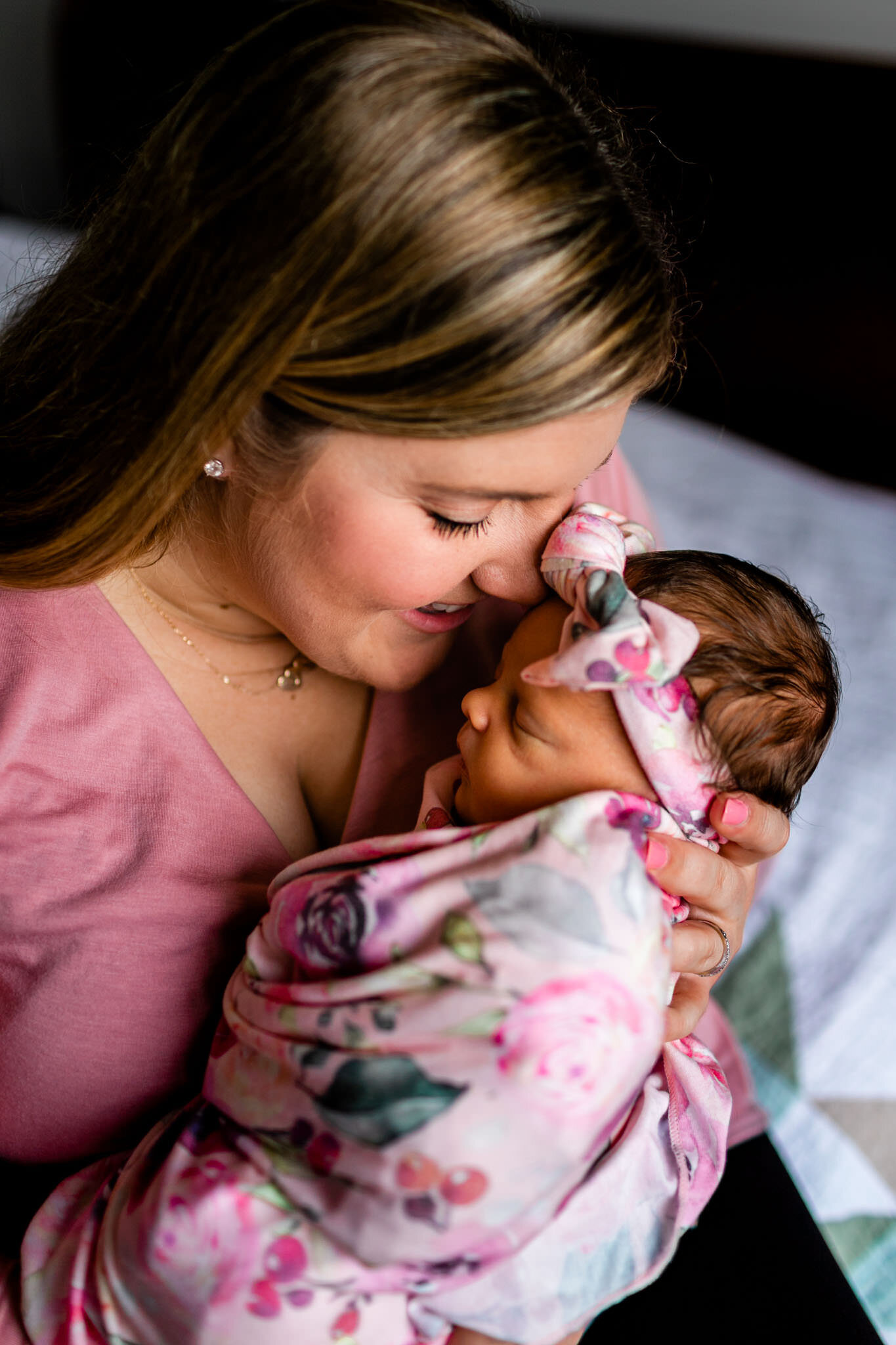 Raleigh Newborn Photographer | By G. Lin Photography | Close up of mother holding baby girl close to her face