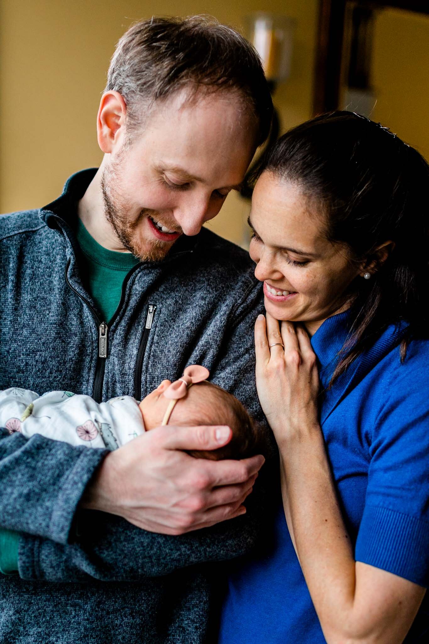 Durham Newborn Photographer | By G. Lin Photography | Man and woman standing and looking at baby